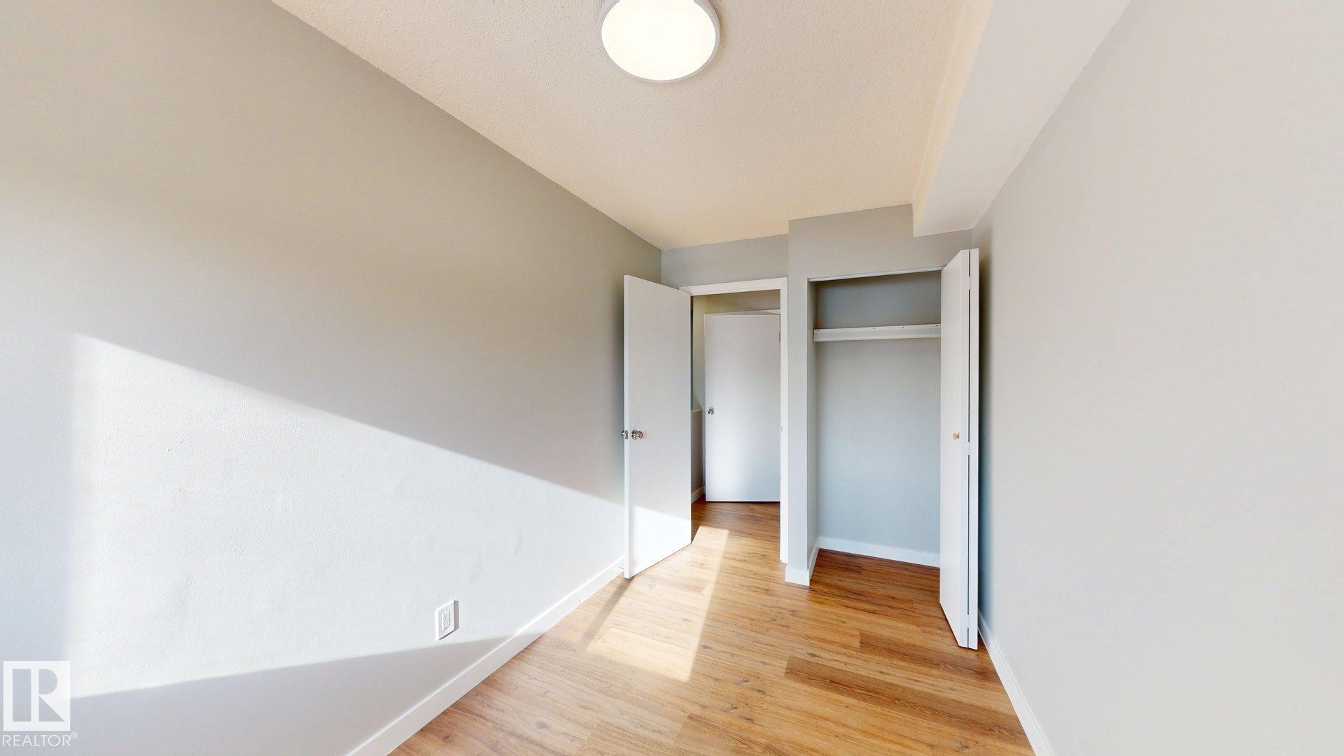 Unfurnished bedroom featuring light wood-style flooring and baseboards - 611 2908 116A Avenue, Edmonton, AB - Indoor Photo Showing Other Room