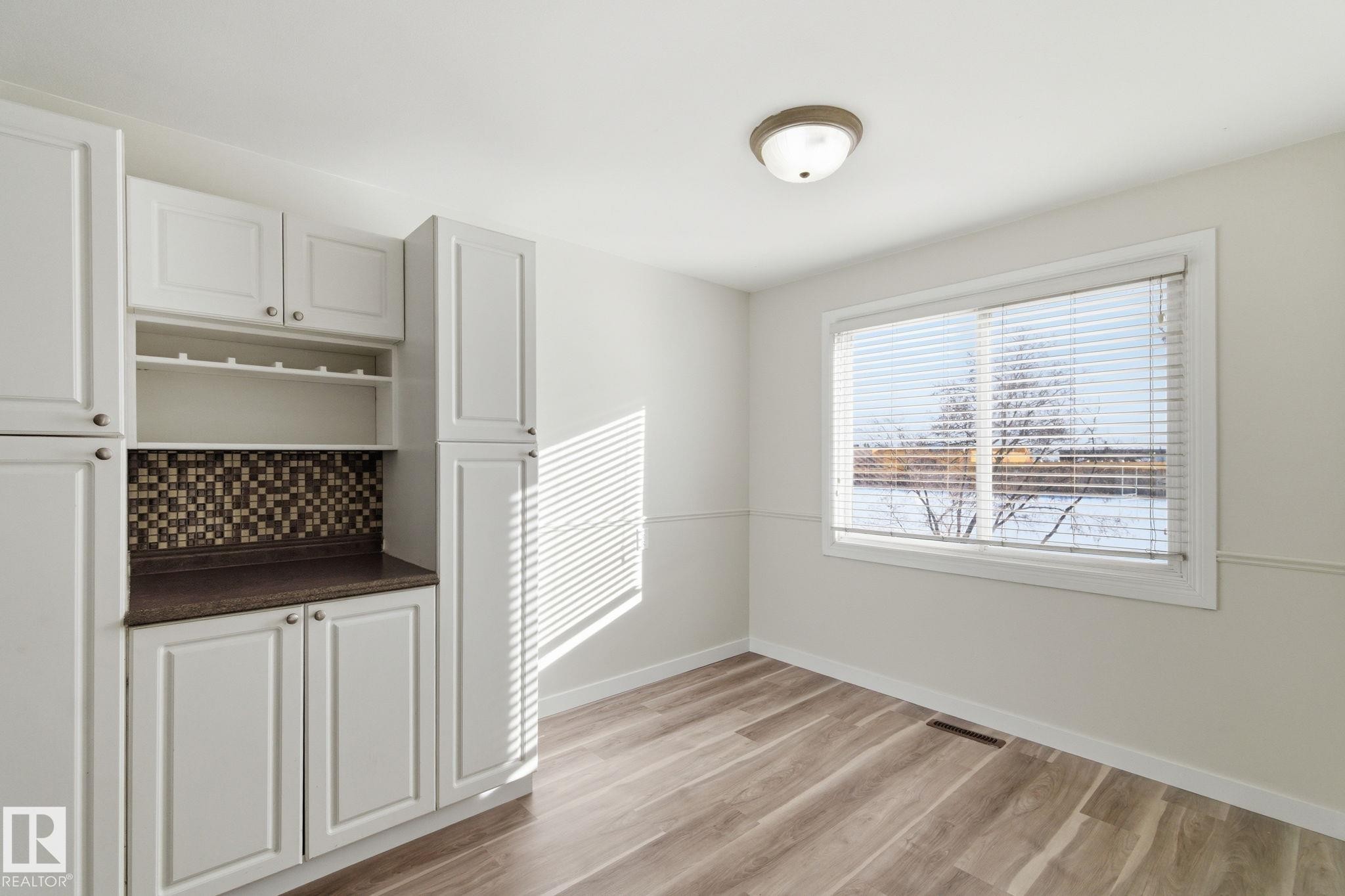 Unfurnished dining area with light wood-type flooring and baseboards - 180 Londonderry Square, Edmonton, AB - Indoor Photo Showing Other Room