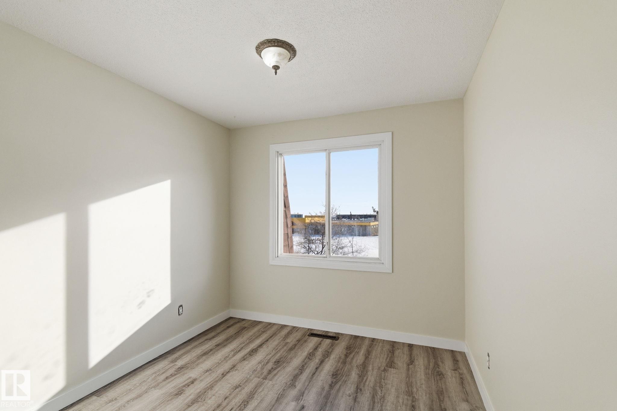 Spare room with light wood finished floors and baseboards - 180 Londonderry Square, Edmonton, AB - Indoor Photo Showing Other Room