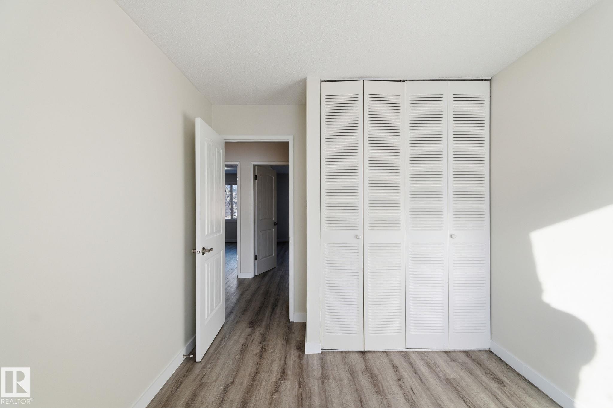 Unfurnished bedroom featuring light wood-style floors and a closet - 180 Londonderry Square, Edmonton, AB - Indoor Photo Showing Other Room