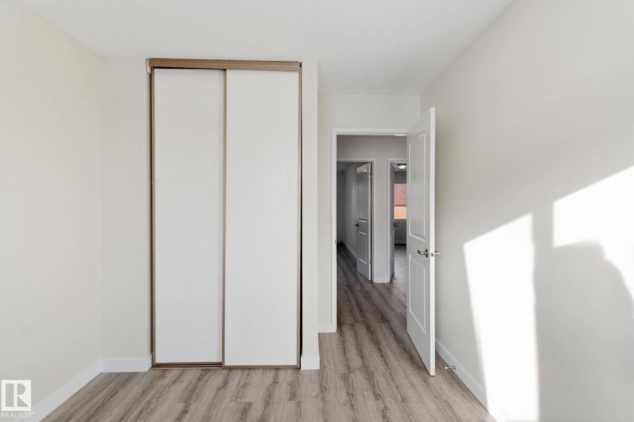 Unfurnished bedroom featuring a closet and light wood-style flooring - 180 Londonderry Square, Edmonton, AB - Indoor Photo Showing Other Room