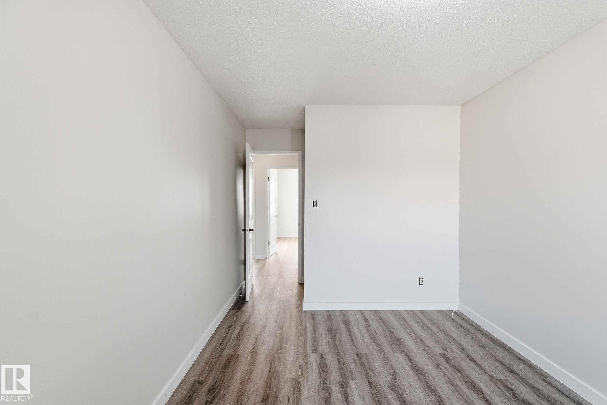 Spare room with wood finished floors and baseboards - 180 Londonderry Square, Edmonton, AB - Indoor Photo Showing Other Room