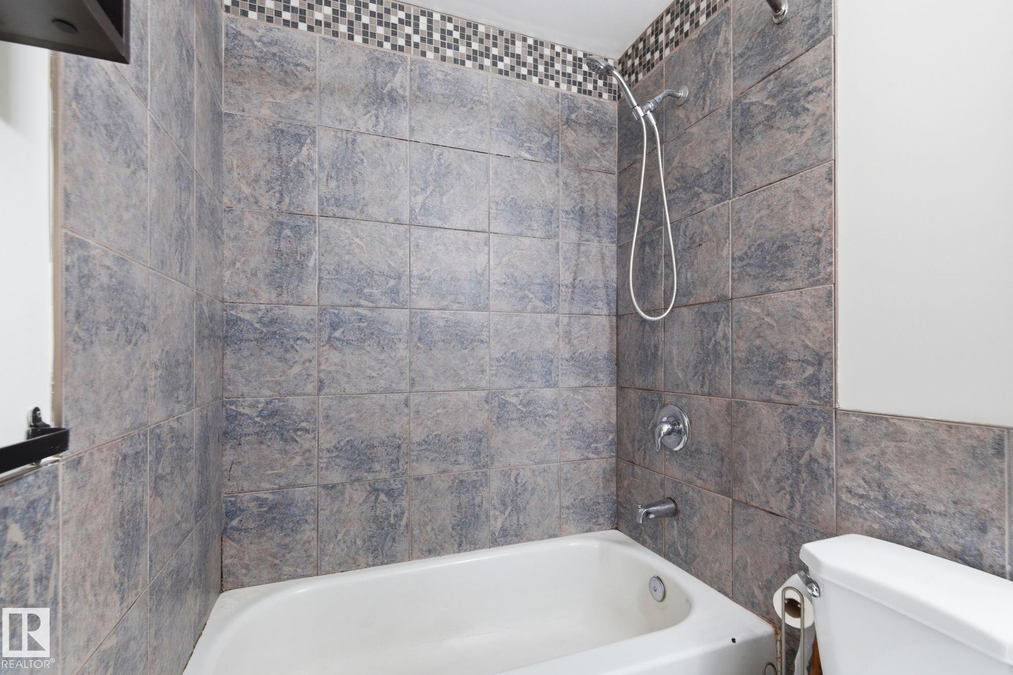 Full bath with shower / bath combination and tile walls - 180 Londonderry Square, Edmonton, AB - Indoor Photo Showing Bathroom