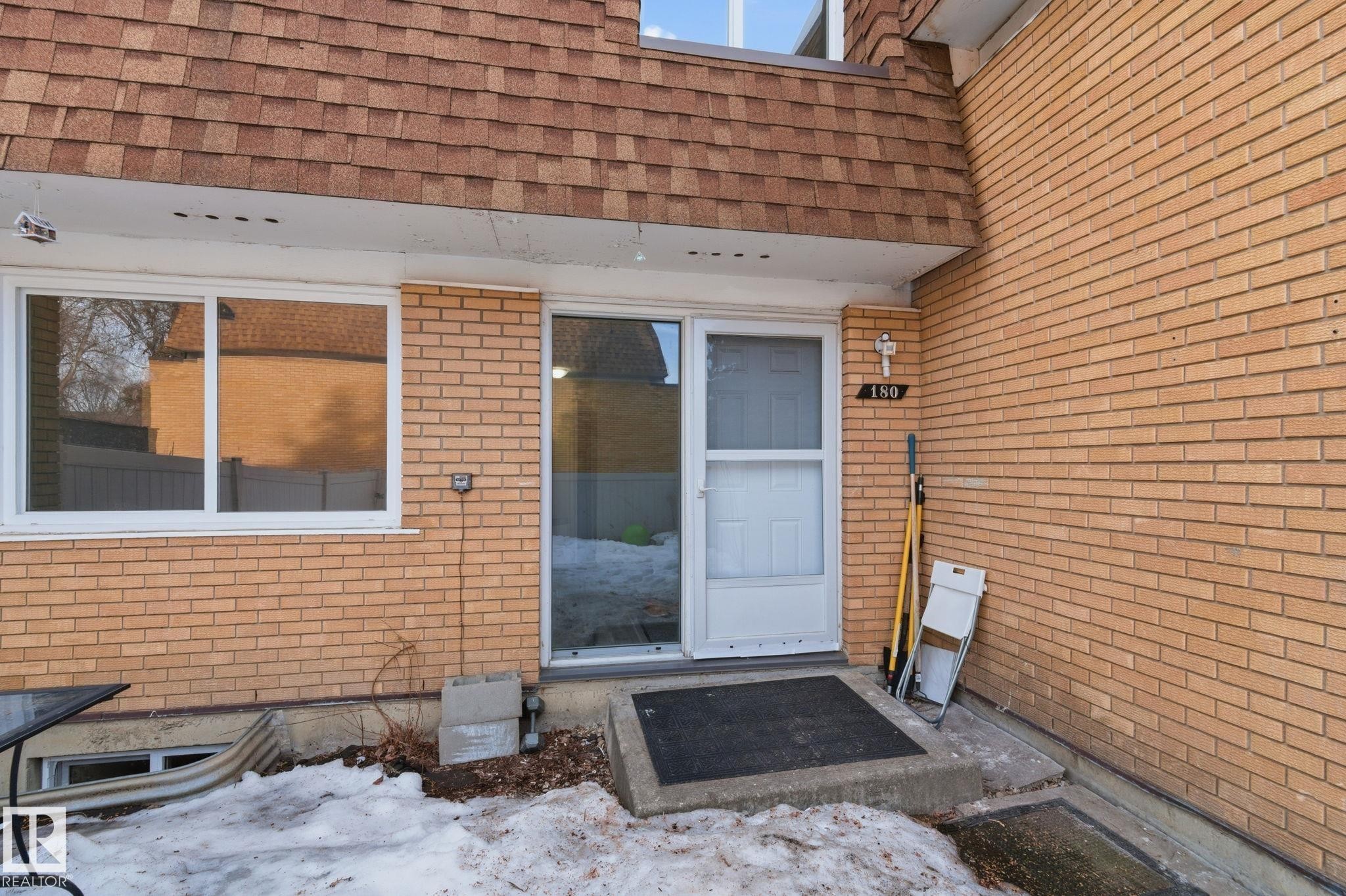Entrance to property with brick siding and roof with shingles - 180 Londonderry Square, Edmonton, AB - Outdoor With Exterior