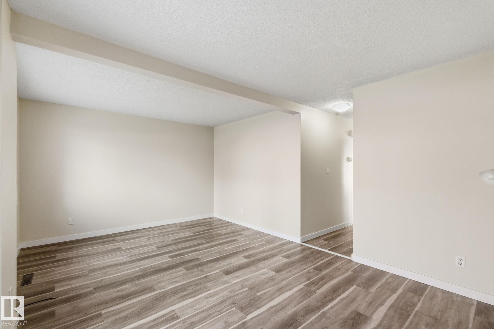 Spare room with light wood-type flooring and baseboards - 180 Londonderry Square, Edmonton, AB - Indoor Photo Showing Other Room