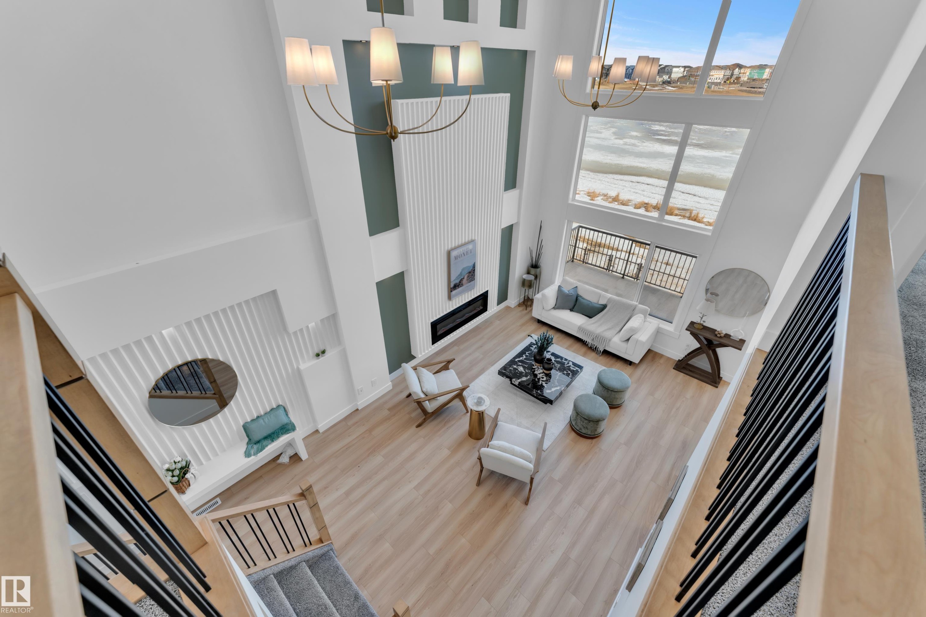 Living area with a chandelier, wood finished floors, a high ceiling, and a fireplace - 228 Linden Loop, Leduc, AB - Indoor Photo Showing Other Room
