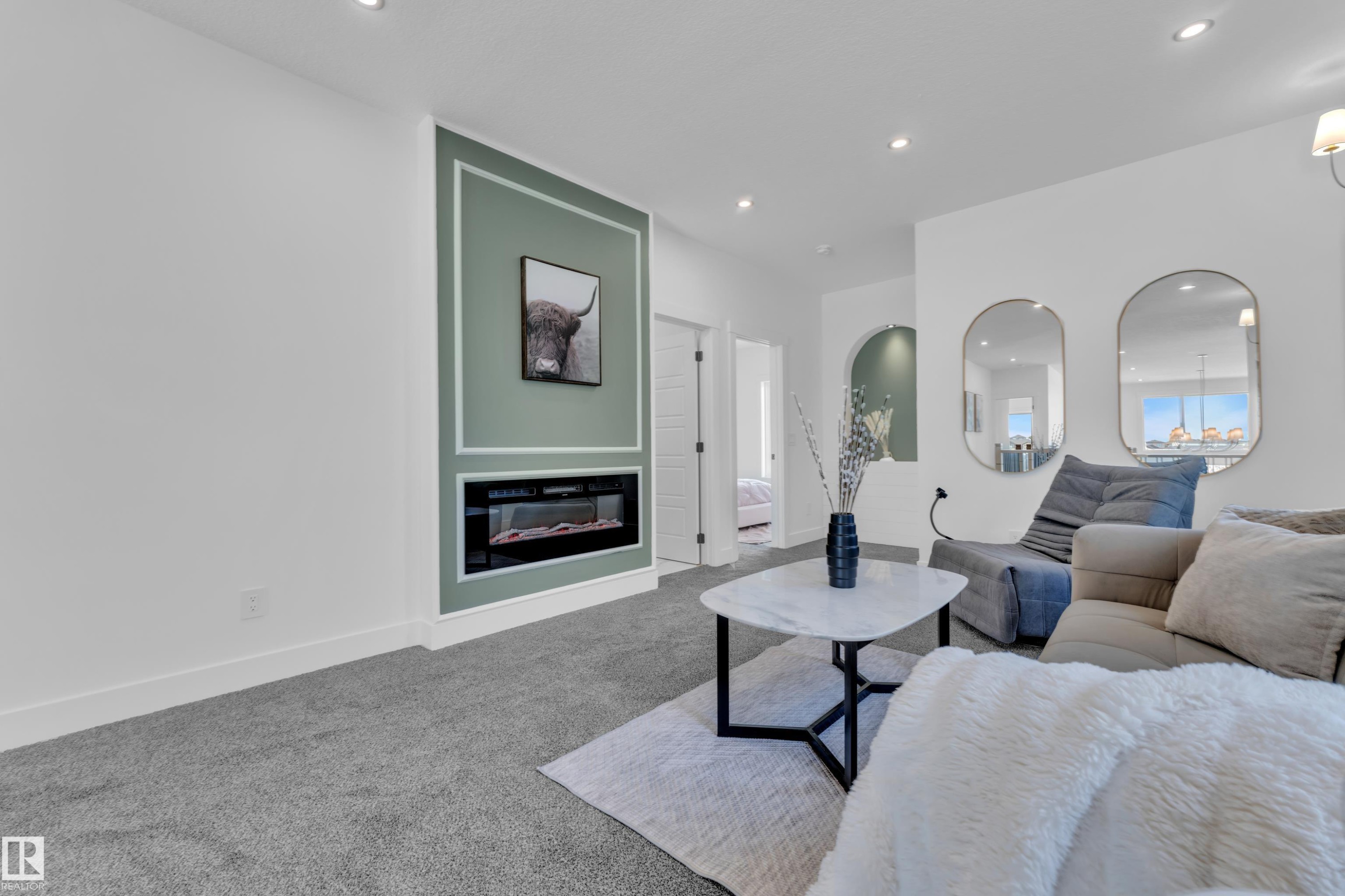 Living room with carpet floors, a glass covered fireplace, and recessed lighting - 228 Linden Loop, Leduc, AB - Indoor Photo Showing Living Room With Fireplace