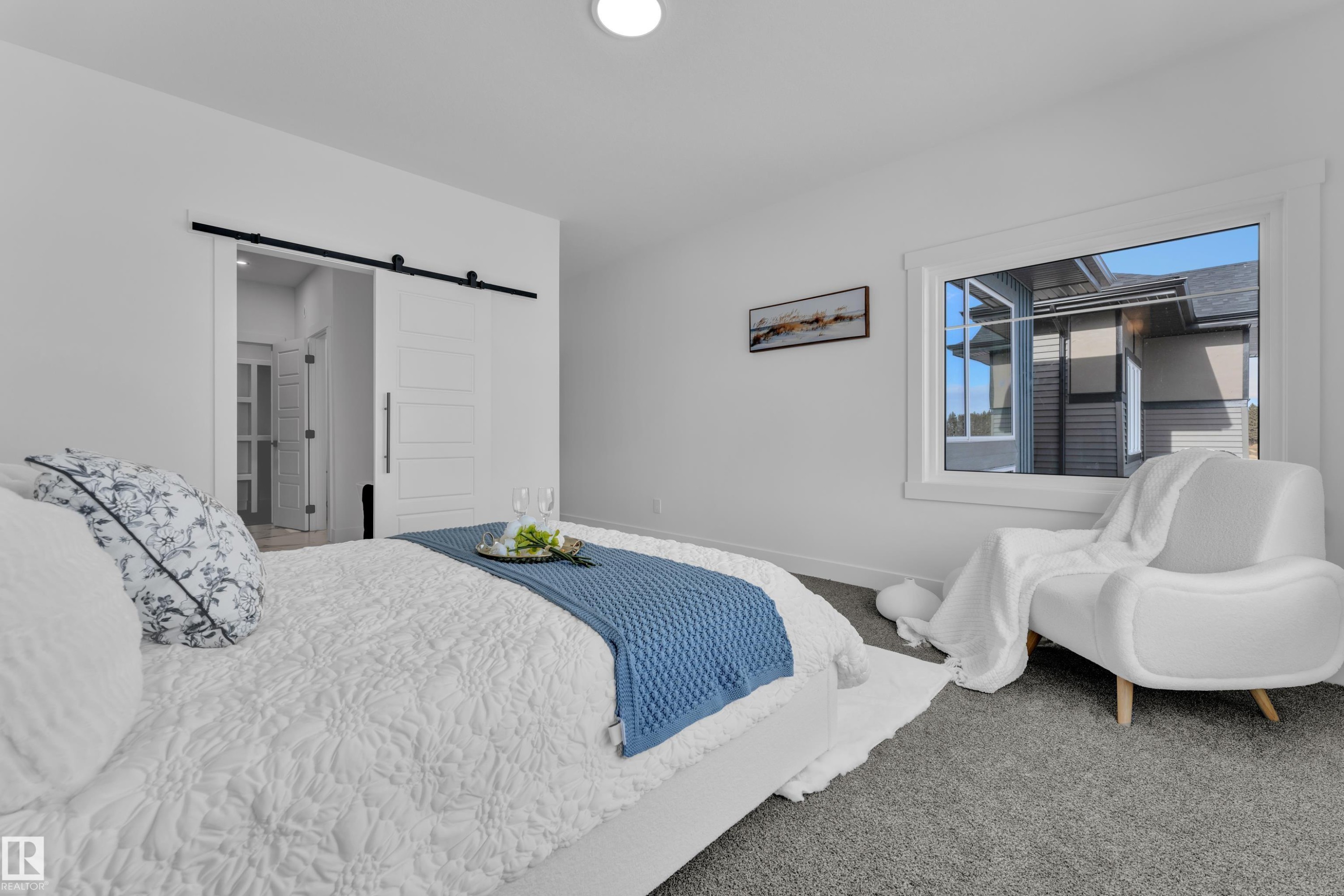 Bedroom with a barn door and carpet - 228 Linden Loop, Leduc, AB - Indoor Photo Showing Bedroom