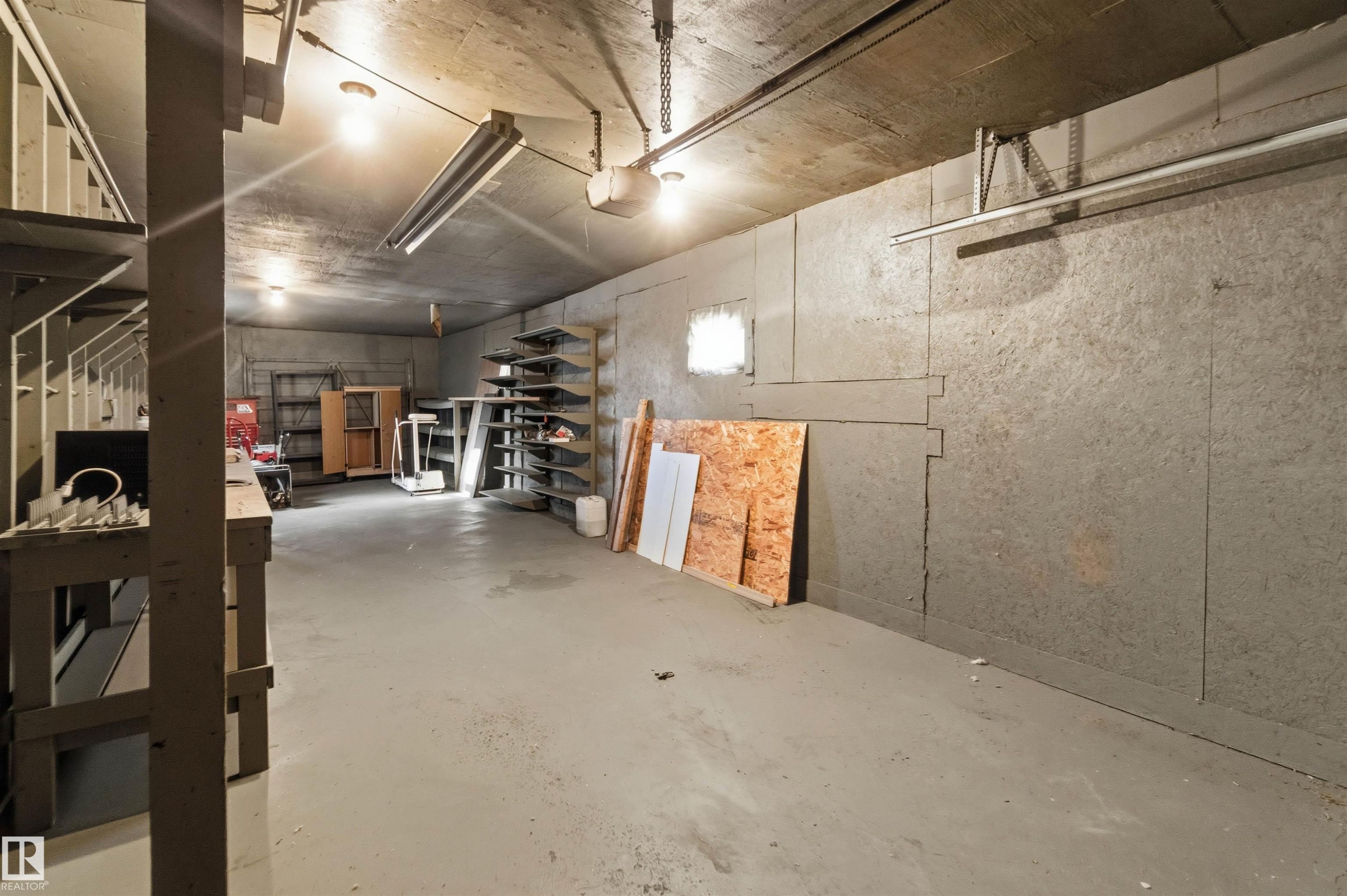 Garage with a garage door opener - 135 Humberstone Road, Edmonton, AB - Indoor Photo Showing Garage