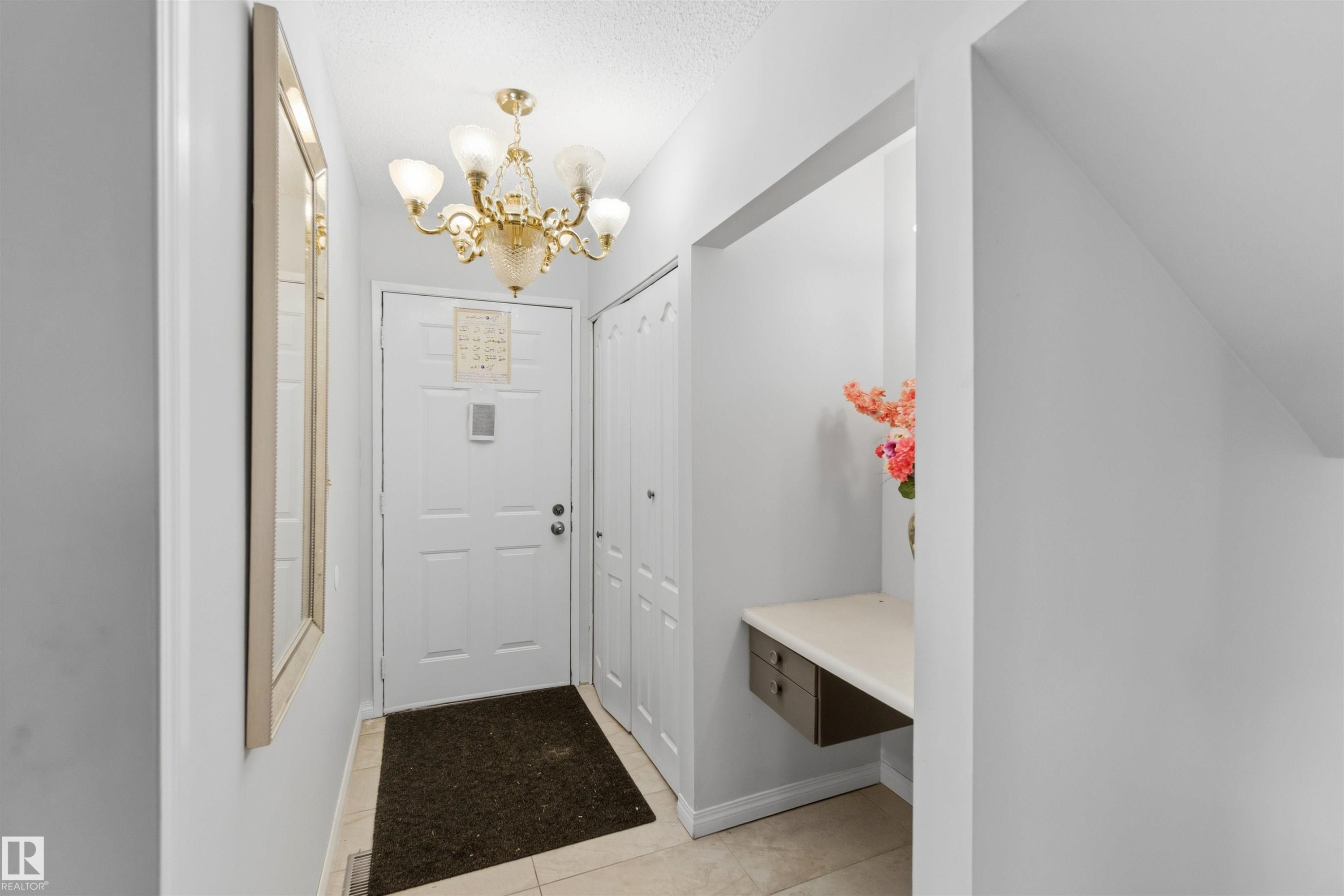 Mudroom featuring suspended lighting and light tile patterned floors - 135 Humberstone Road, Edmonton, AB - Indoor Photo Showing Other Room