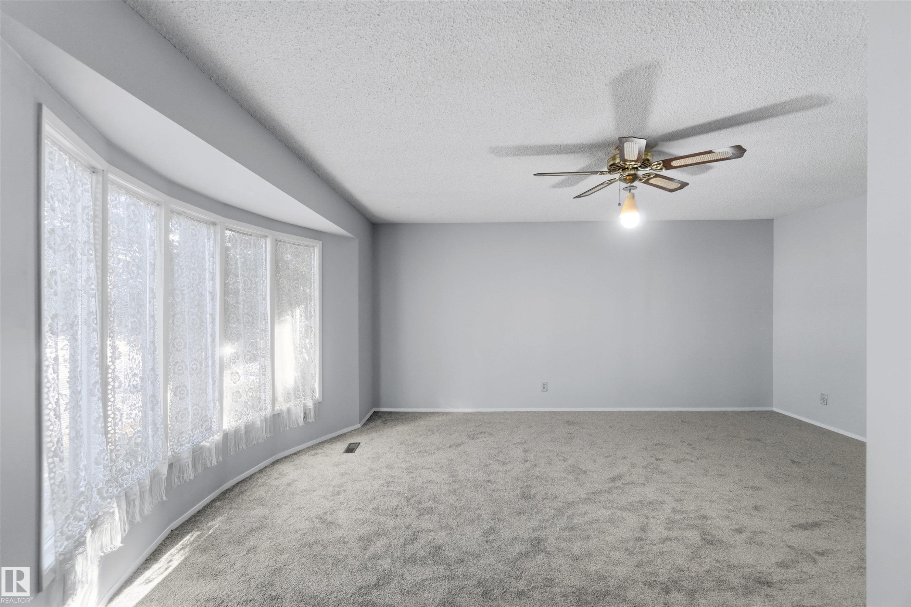 Carpeted spare room with a ceiling fan and a textured ceiling - 135 Humberstone Road, Edmonton, AB - Indoor Photo Showing Other Room