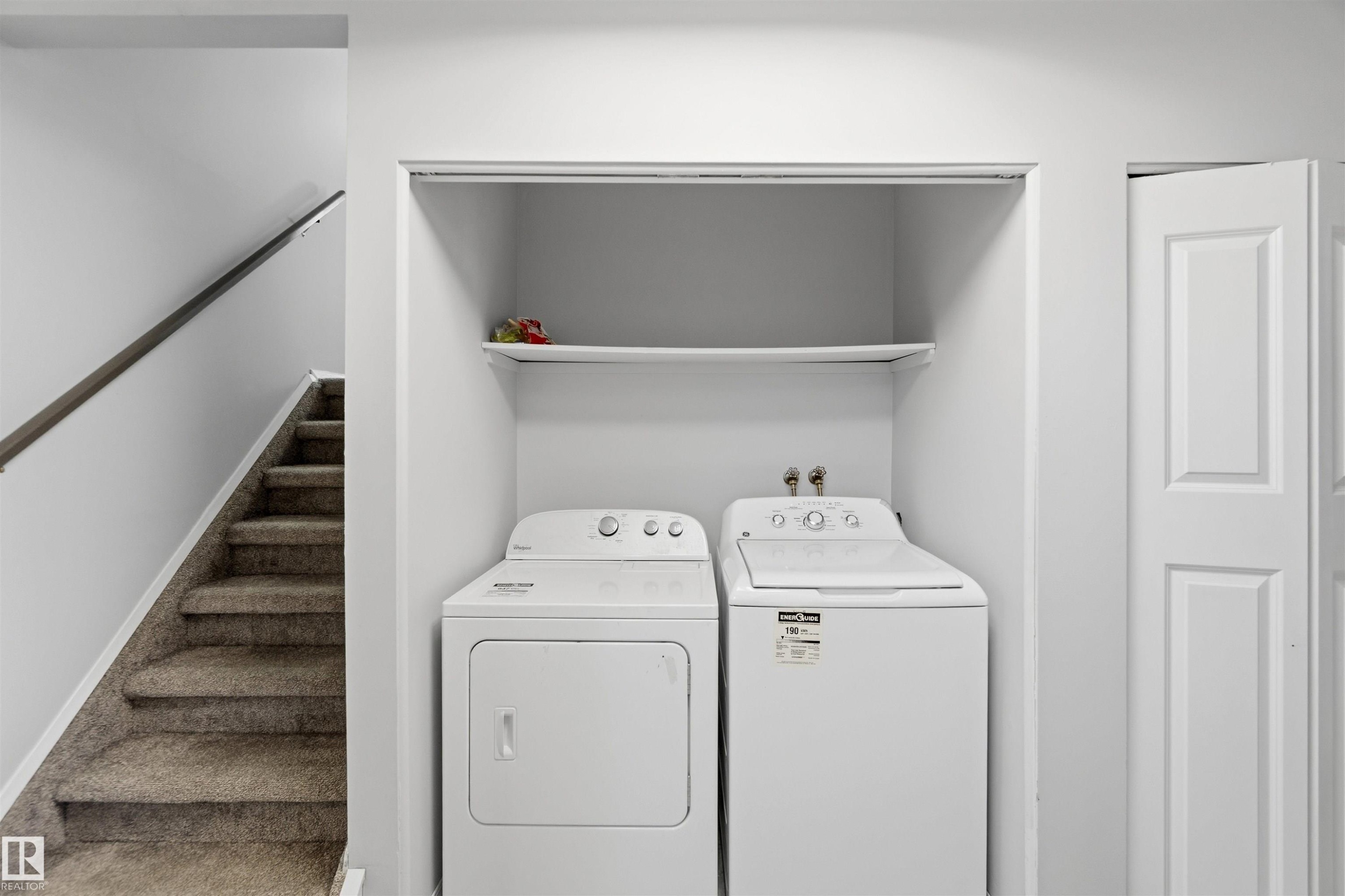 Laundry area featuring washing machine and dryer and baseboards - 135 Humberstone Road, Edmonton, AB - Indoor Photo Showing Laundry Room