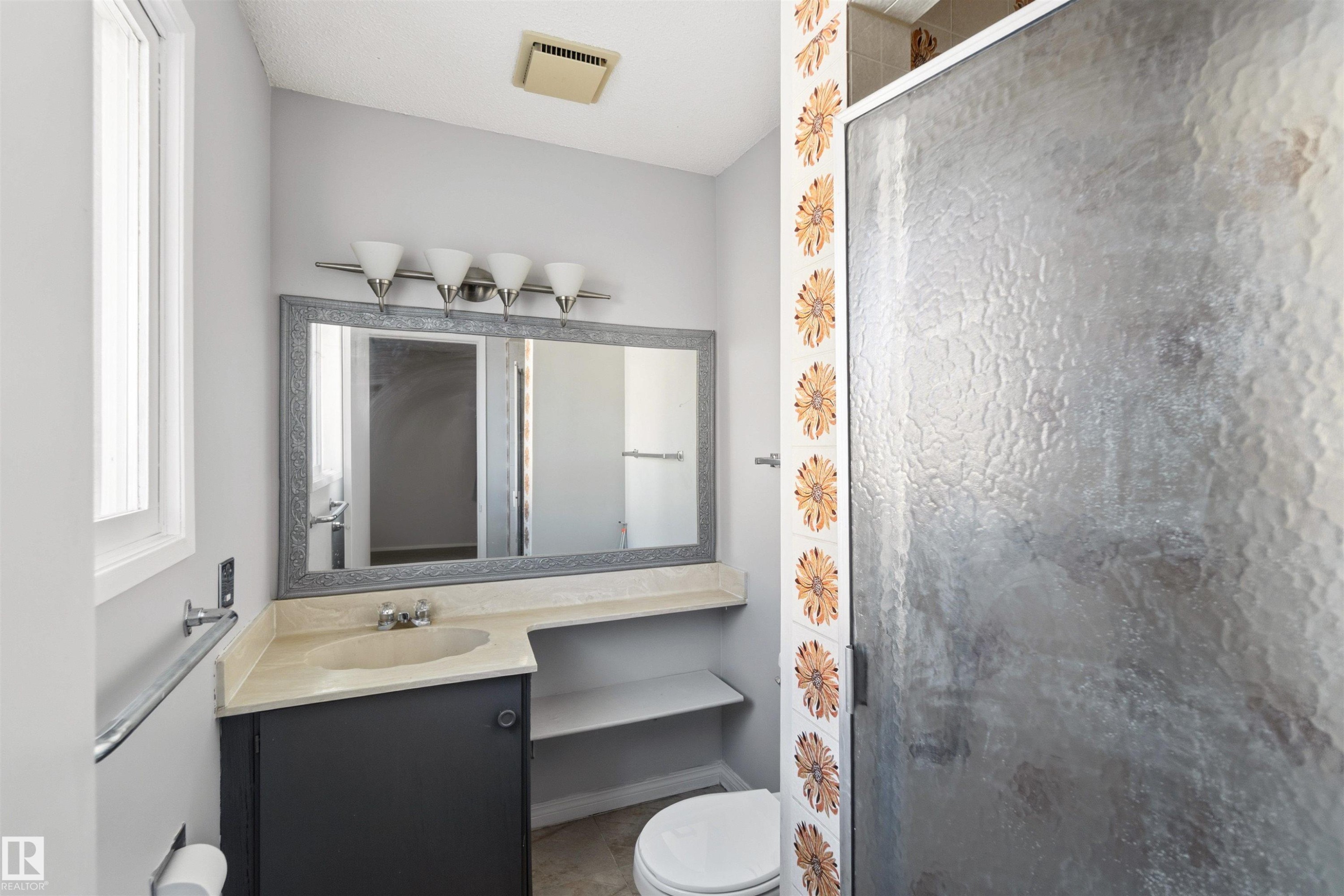Bathroom featuring vanity and a stall shower - 135 Humberstone Road, Edmonton, AB - Indoor Photo Showing Bathroom