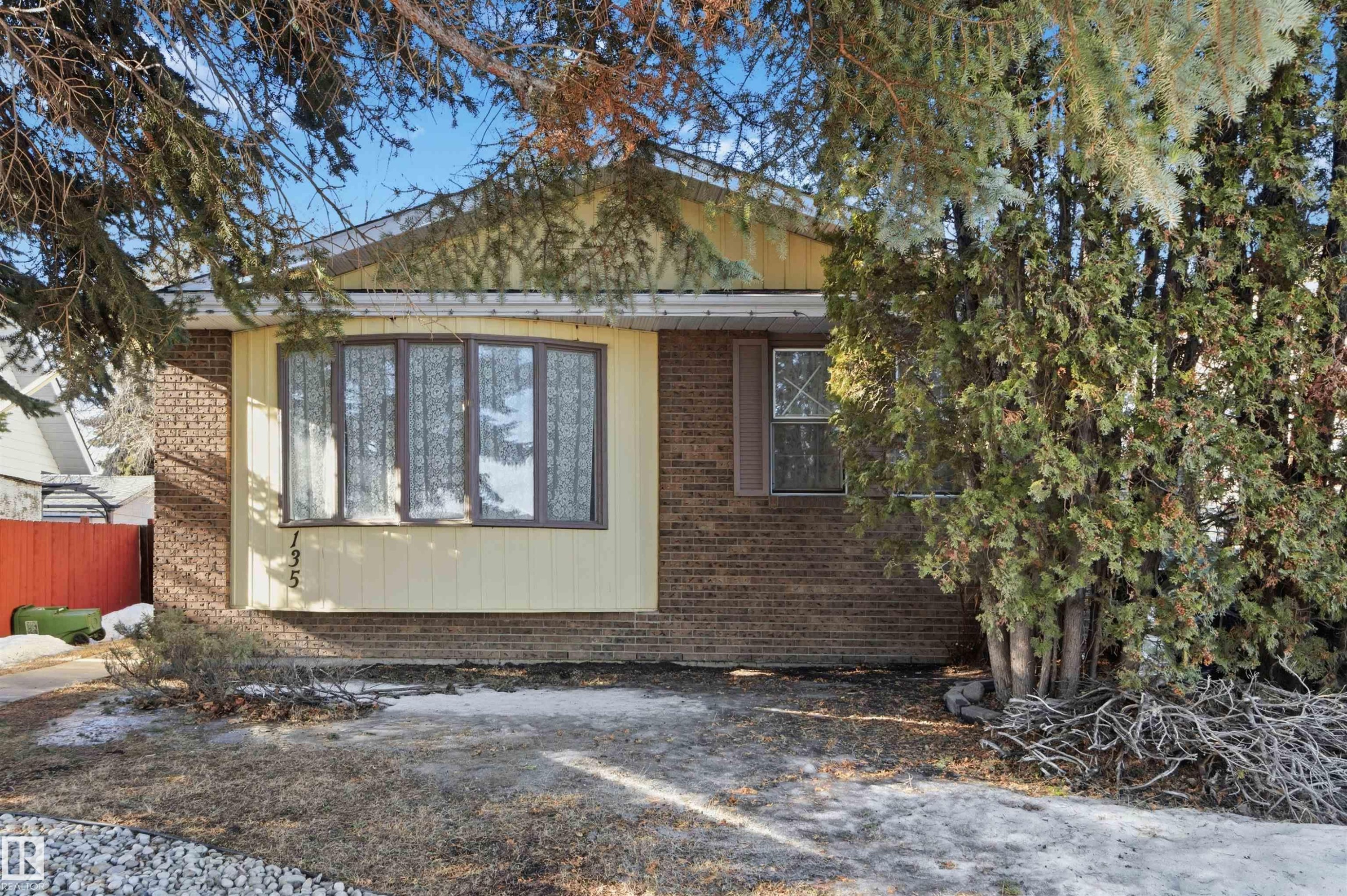 View of side of home with brick siding - 135 Humberstone Road, Edmonton, AB - Outdoor