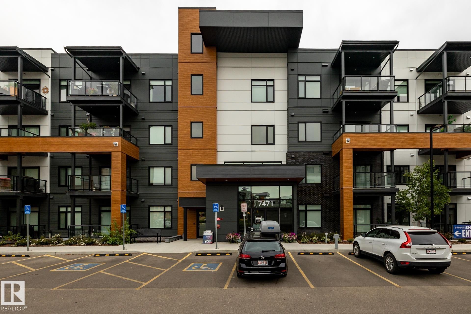 View of apartment building / complex with uncovered parking - 112 7471 May Common, Edmonton, AB - Outdoor With Facade