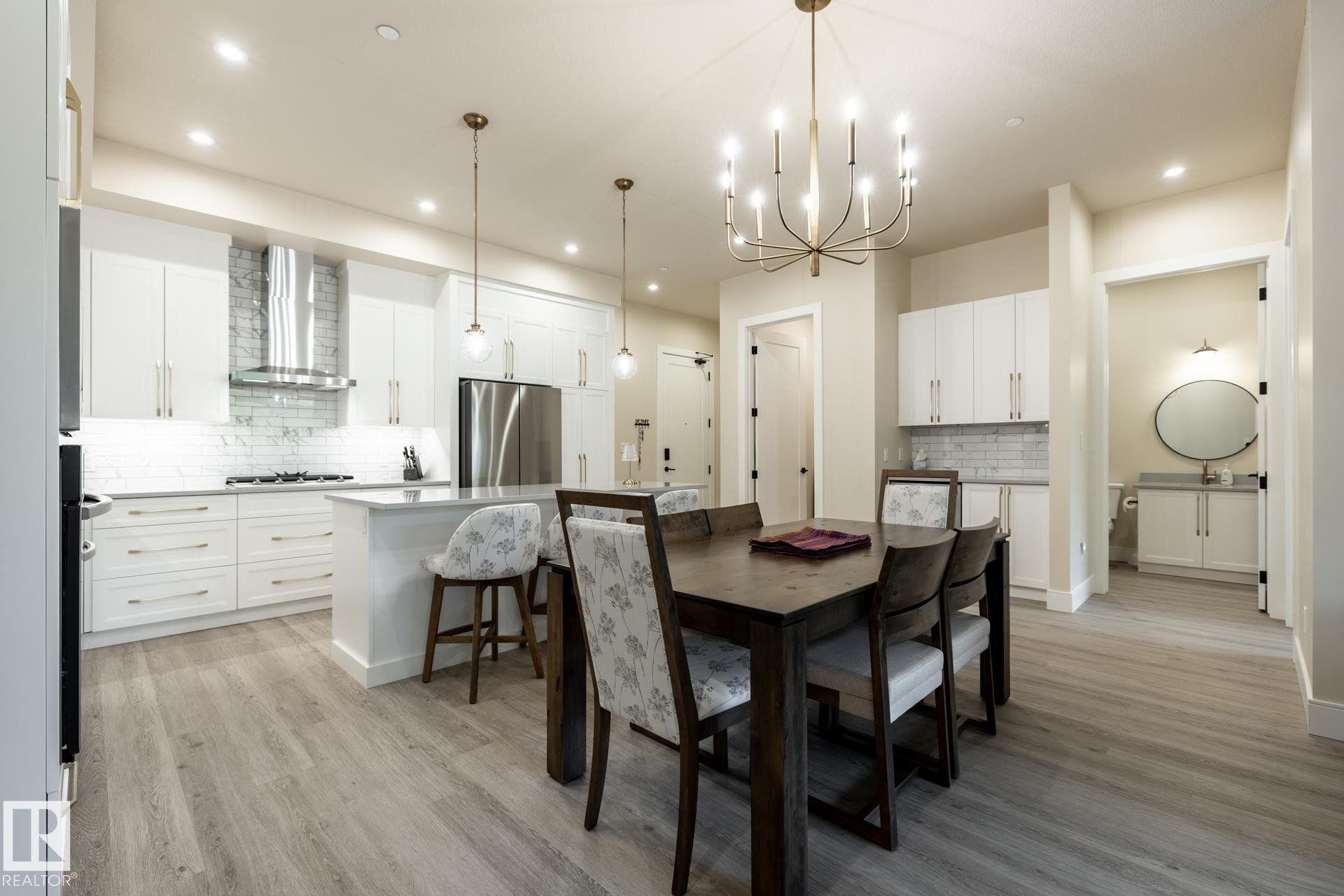 Dining space with a chandelier, light wood-type flooring, and recessed lighting - 112 7471 May Common, Edmonton, AB - Indoor Photo Showing Dining Room