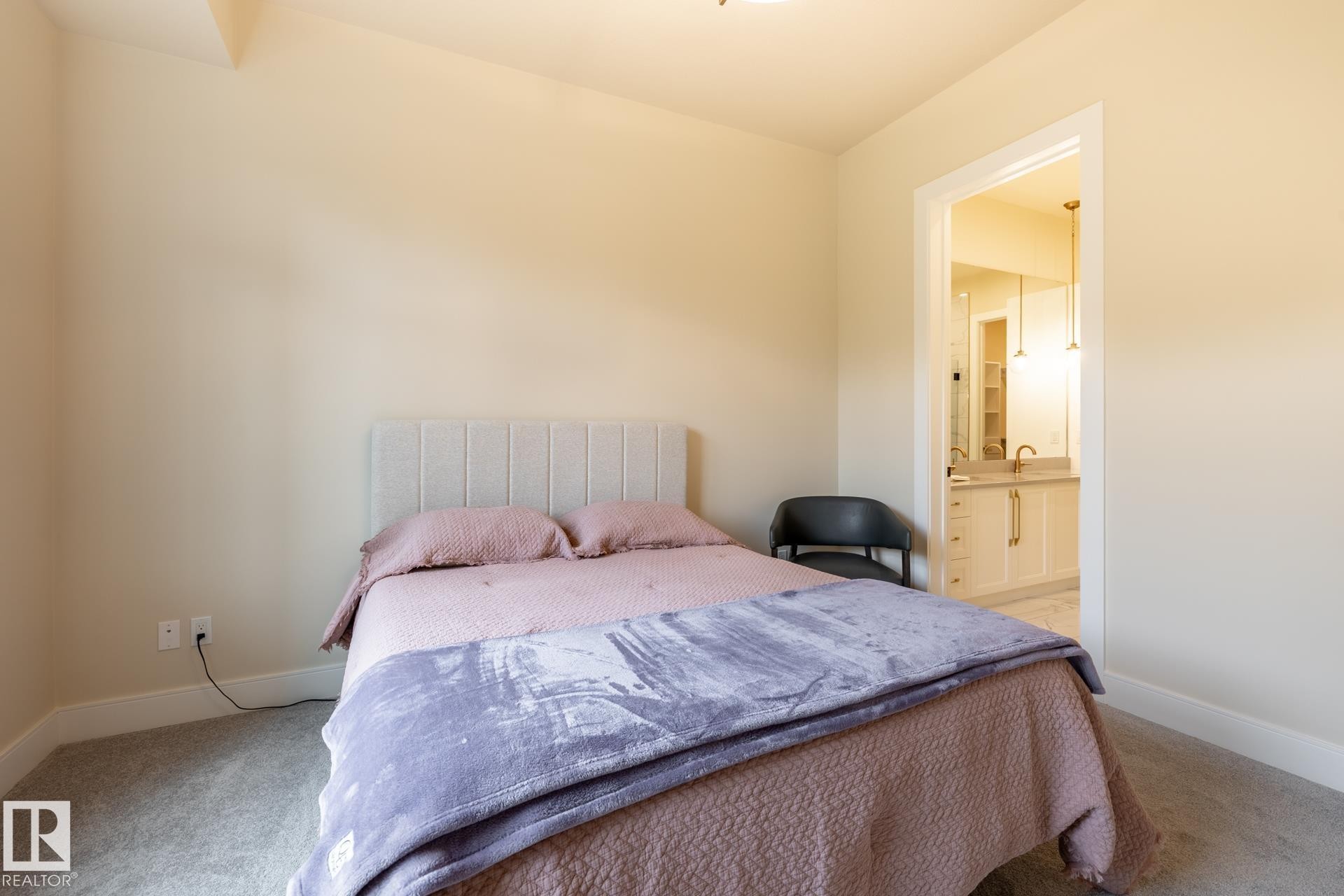 Bedroom with light colored carpet and ensuite bathroom - 112 7471 May Common, Edmonton, AB - Indoor Photo Showing Bedroom