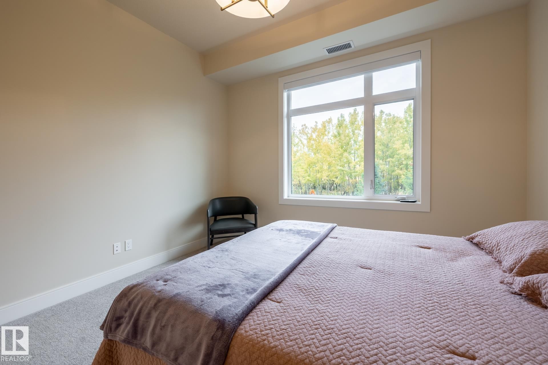 Carpeted bedroom featuring baseboards - 112 7471 May Common, Edmonton, AB - Indoor Photo Showing Bedroom