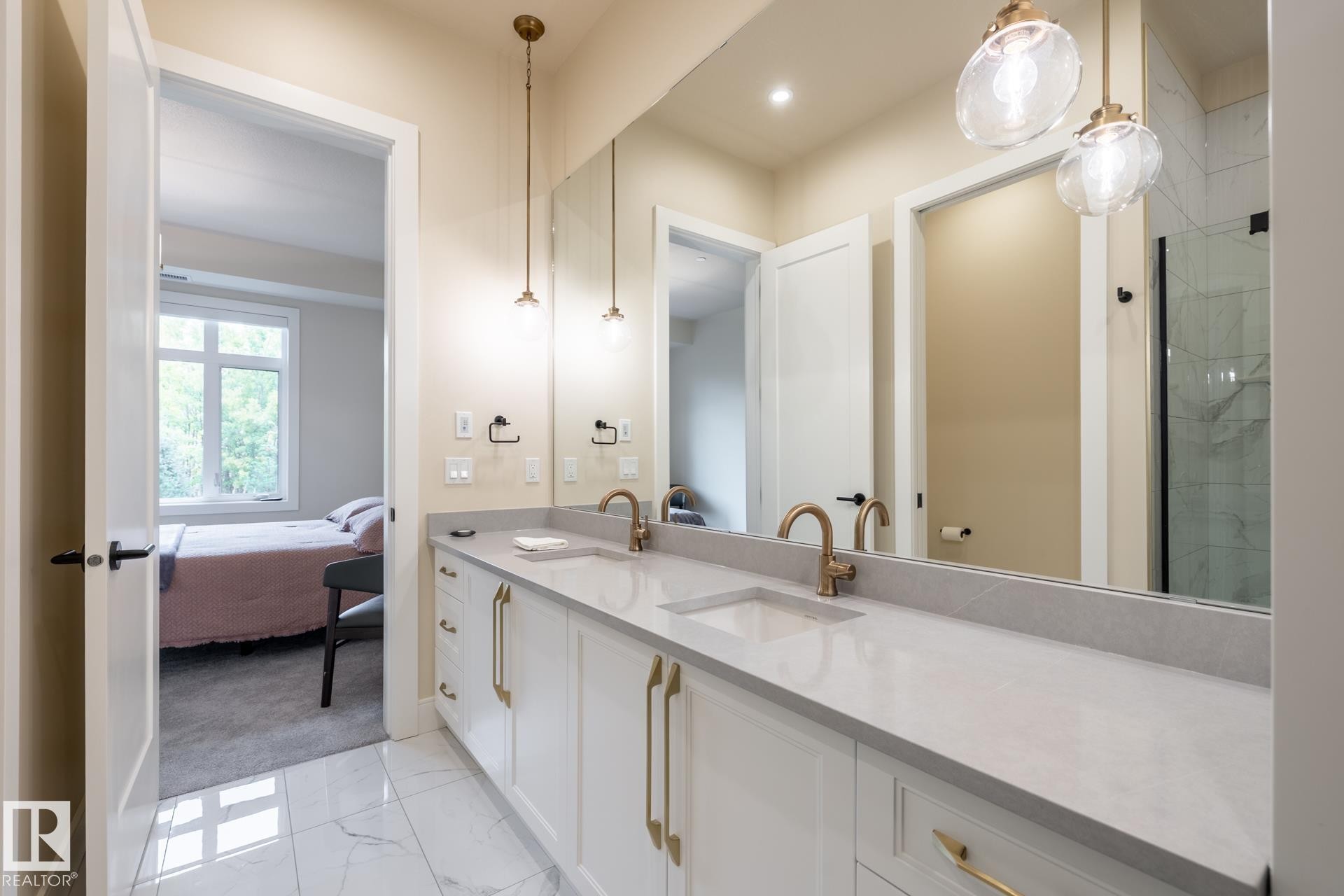 Ensuite bathroom featuring double vanity and light marble finish floors - 112 7471 May Common, Edmonton, AB - Indoor Photo Showing Bathroom