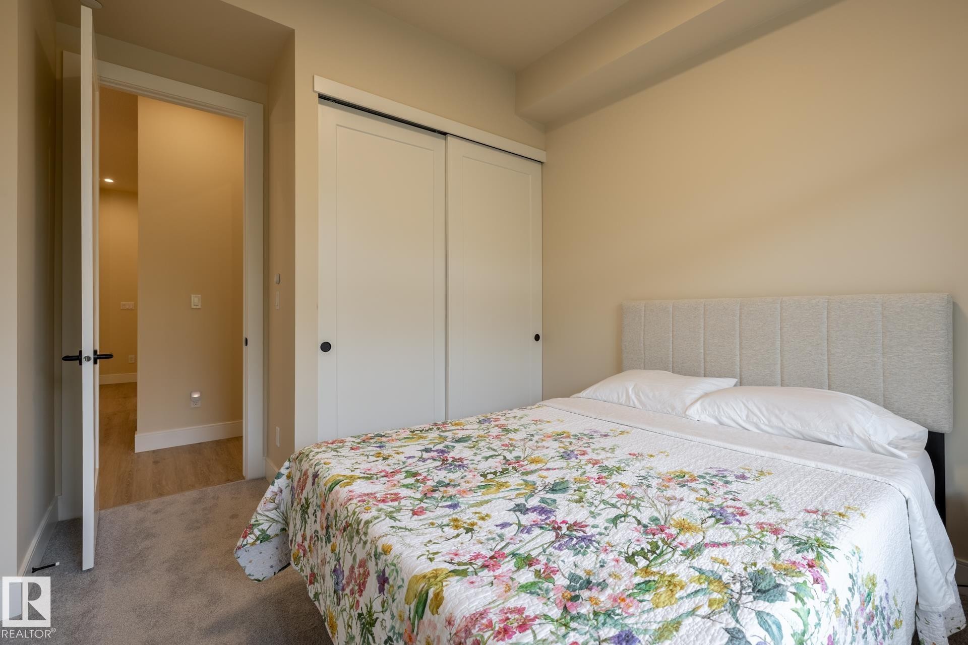 Carpeted bedroom featuring a closet and baseboards - 112 7471 May Common, Edmonton, AB - Indoor Photo Showing Bedroom