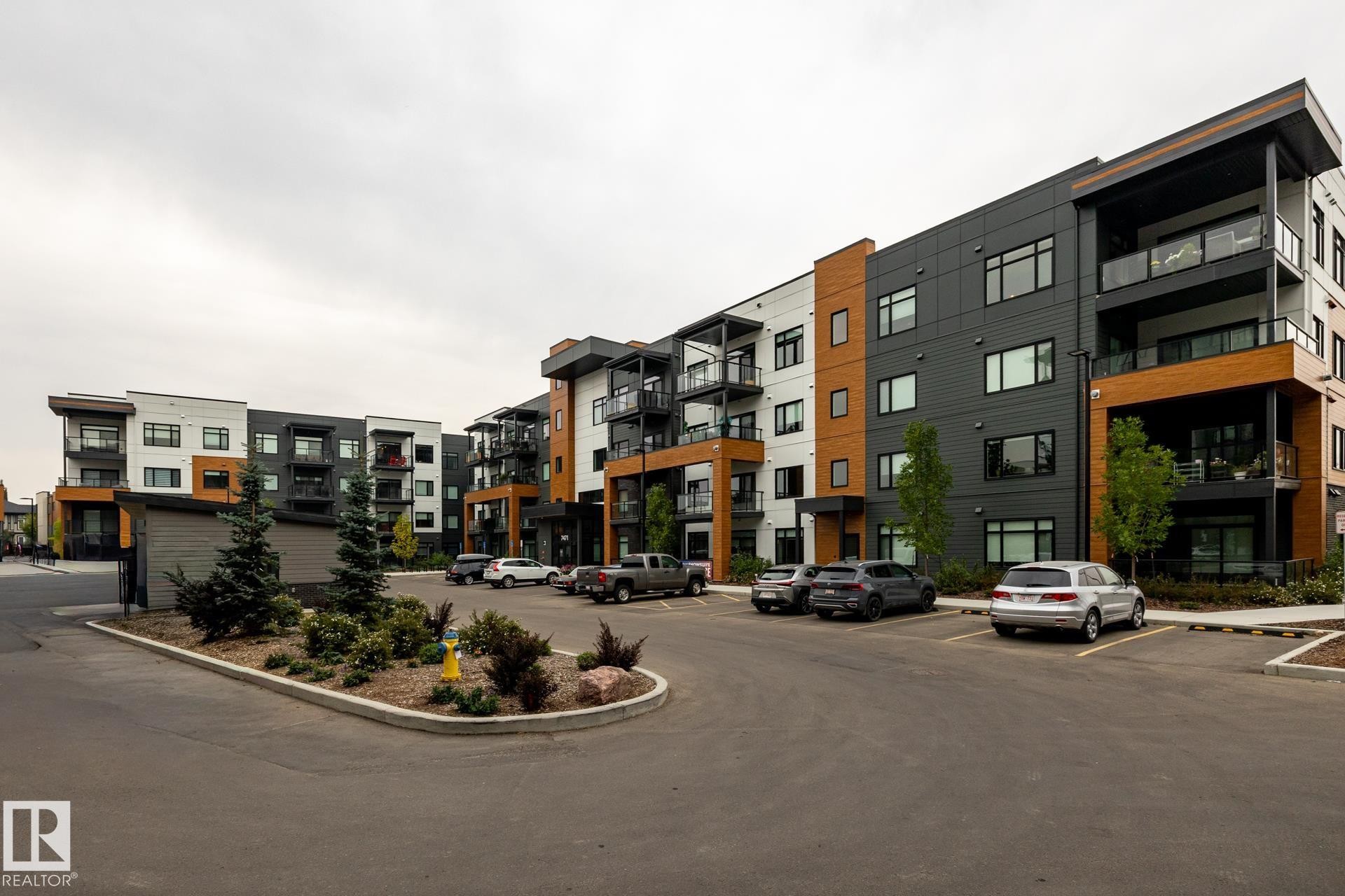 View of property with uncovered parking - 112 7471 May Common, Edmonton, AB - Outdoor With Facade