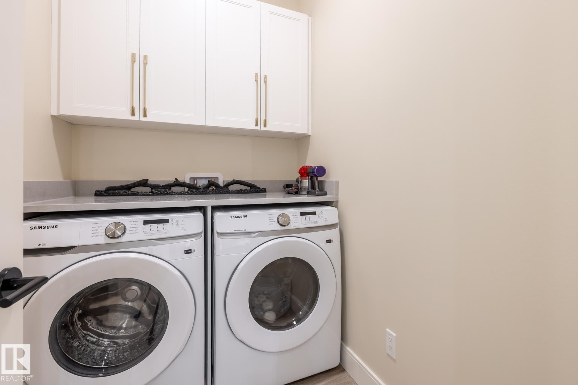 Washroom with cabinet space and washer and clothes dryer - 112 7471 May Common, Edmonton, AB - Indoor Photo Showing Laundry Room