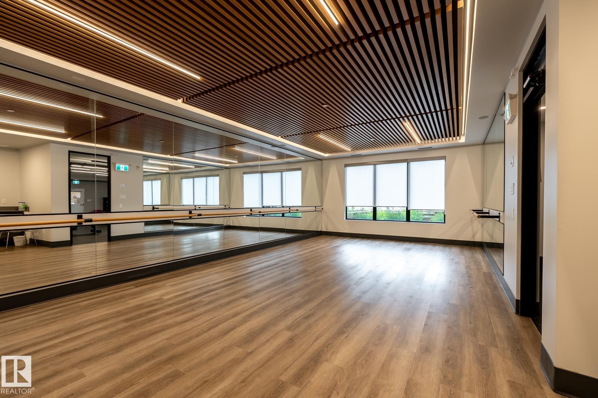 Recreation room with baseboards and light wood-type flooring - 112 7471 May Common, Edmonton, AB - Indoor Photo Showing Other Room