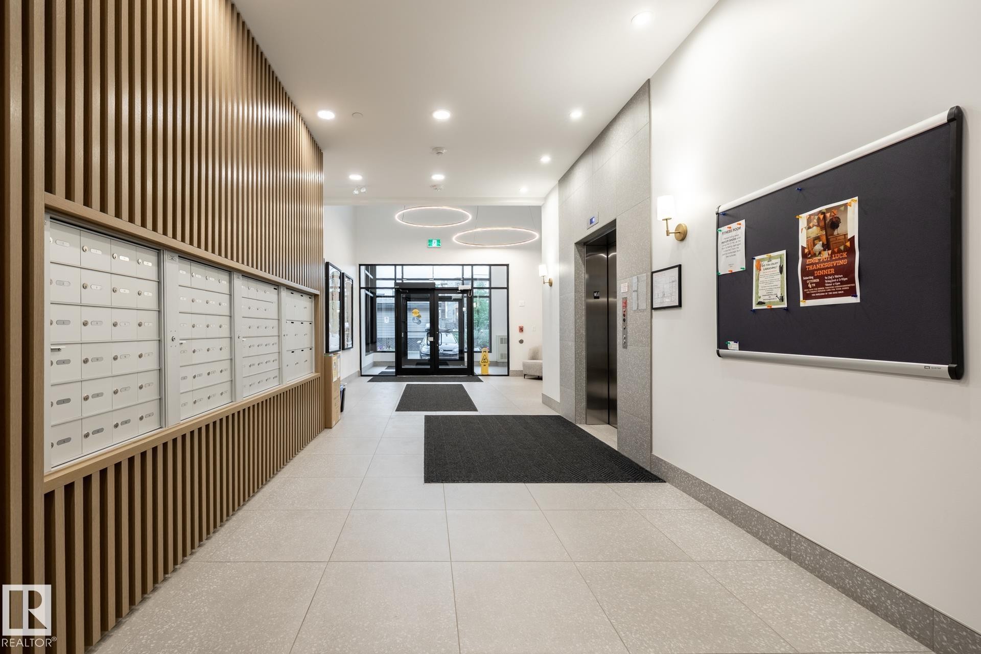 Community lobby with recessed lighting and a high ceiling - 112 7471 May Common, Edmonton, AB - Indoor Photo Showing Other Room
