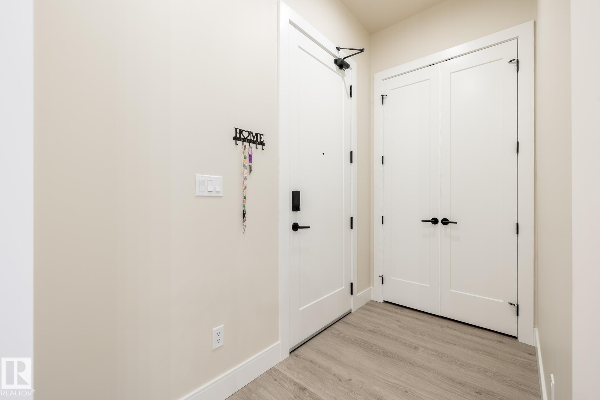 Entryway with wood finished floors and baseboards - 112 7471 May Common, Edmonton, AB - Indoor Photo Showing Other Room