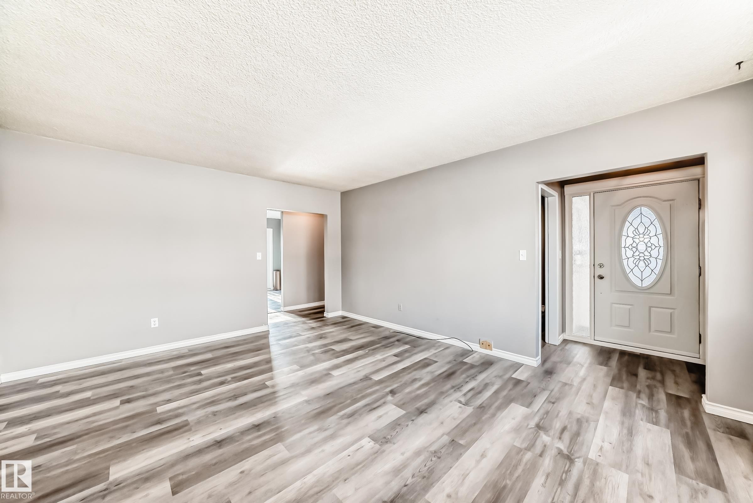 Entryway with light wood-style flooring and a textured ceiling - 8639 64 Avenue Nw, Edmonton, AB - Indoor Photo Showing Other Room
