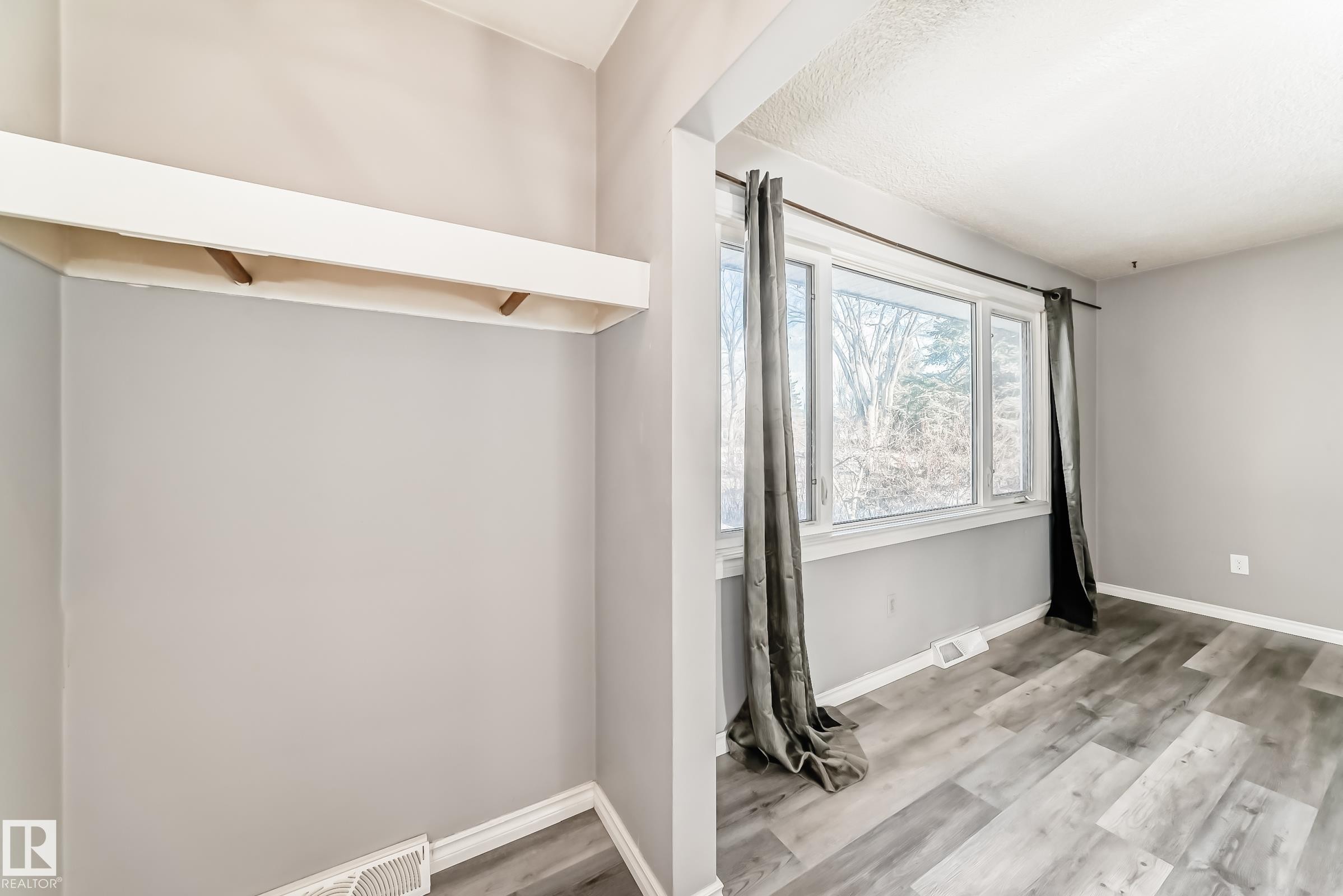 Spare room with light wood-style floors and baseboards - 8639 64 Avenue Nw, Edmonton, AB - Indoor Photo Showing Other Room