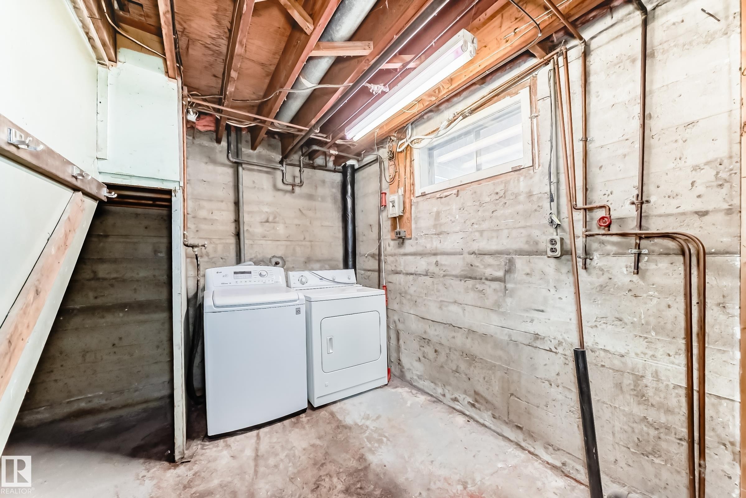 Unfinished basement featuring washing machine and clothes dryer - 8639 64 Avenue Nw, Edmonton, AB - Indoor Photo Showing Laundry Room