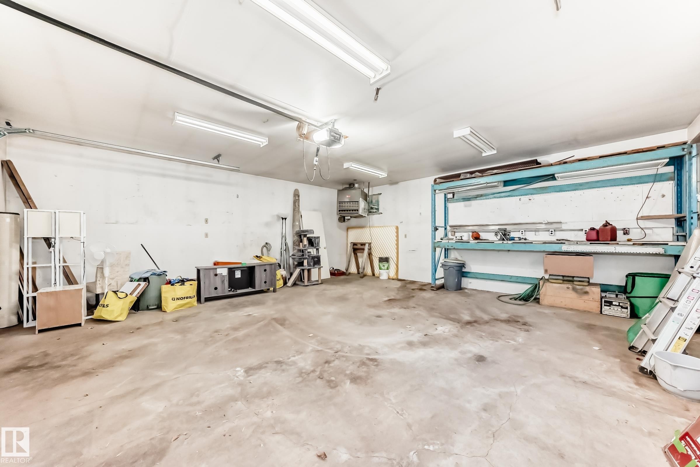 Garage featuring a heating unit - 8639 64 Avenue Nw, Edmonton, AB - Indoor Photo Showing Garage