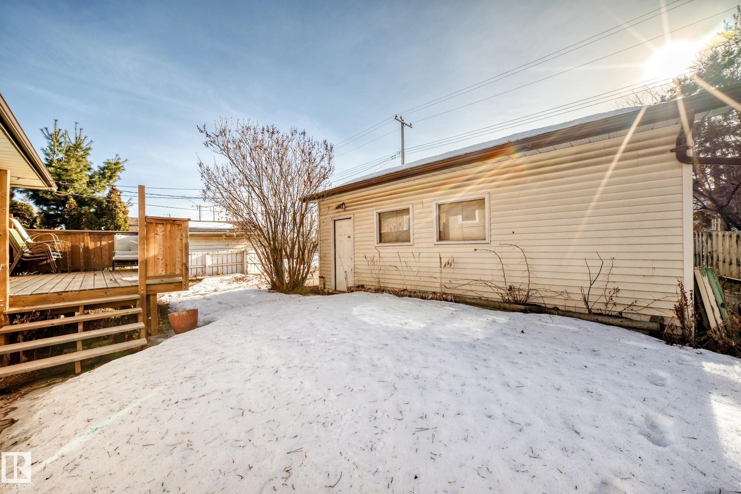 Yard covered in snow featuring a deck - 8639 64 Avenue Nw, Edmonton, AB - Outdoor With Deck Patio Veranda