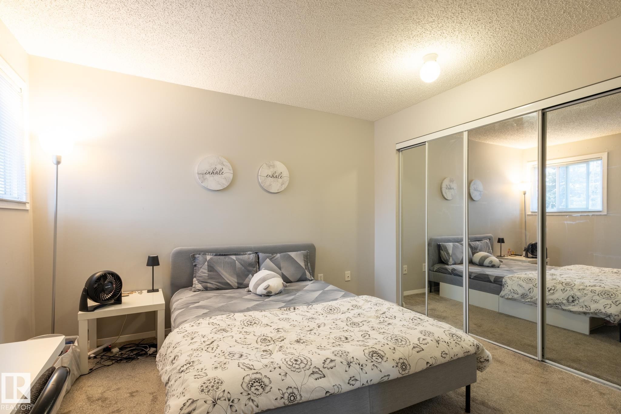 Carpeted bedroom with a textured ceiling and a closet - 3530 42 Street, Edmonton, AB - Indoor Photo Showing Bedroom