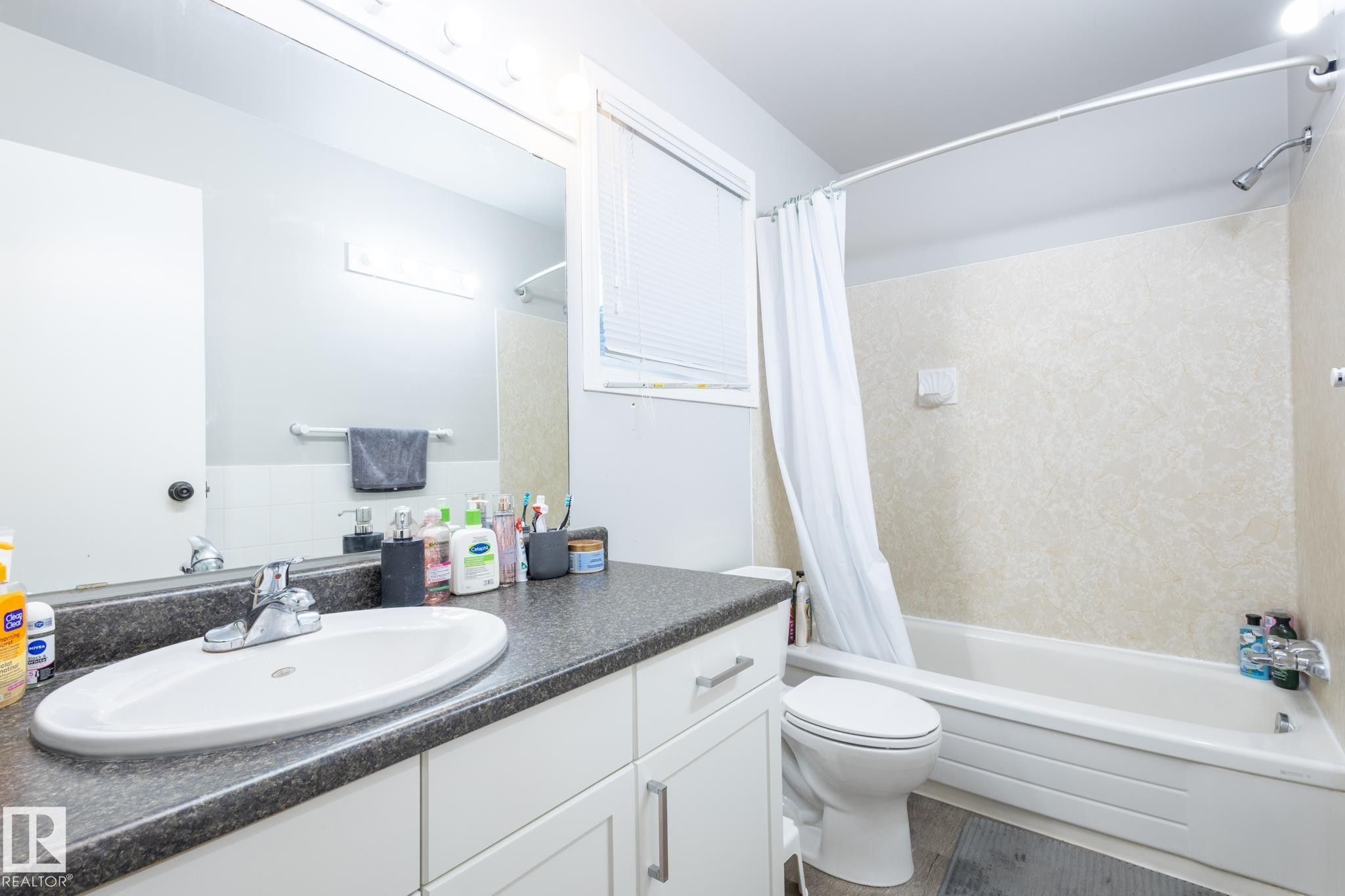 Bathroom featuring shower / bath combo and vanity - 3530 42 Street, Edmonton, AB - Indoor Photo Showing Bathroom