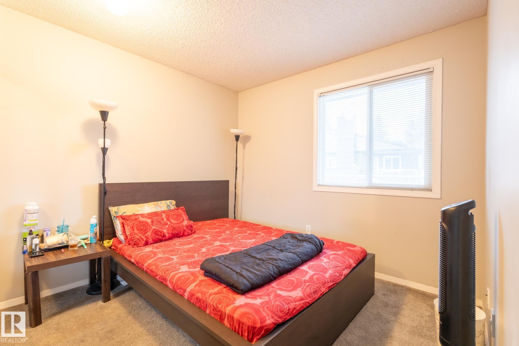 Bedroom with a textured ceiling and carpet - 3530 42 Street, Edmonton, AB - Indoor Photo Showing Bedroom