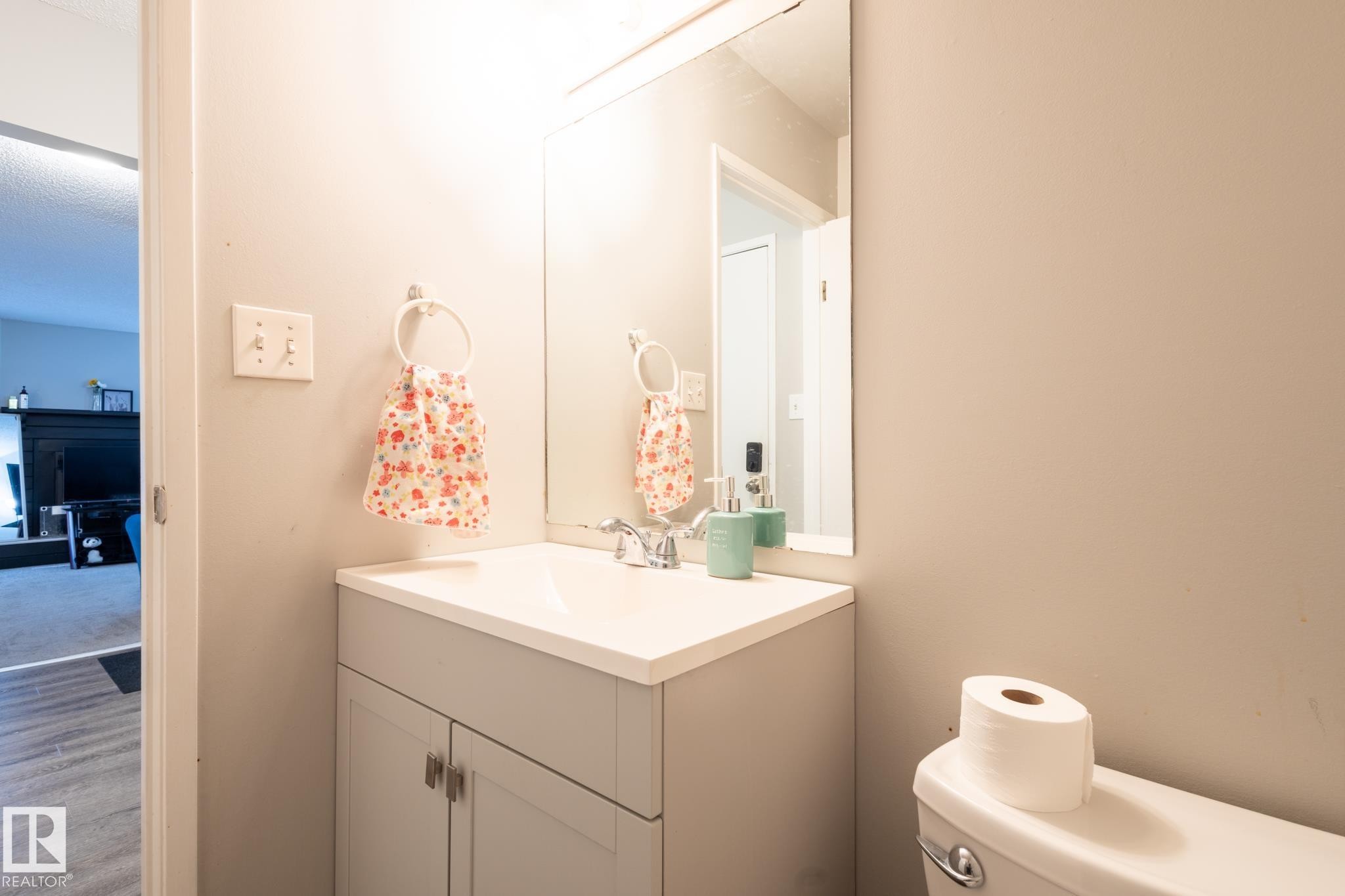 Half bathroom featuring vanity and wood finished floors - 3530 42 Street, Edmonton, AB - Indoor Photo Showing Bathroom