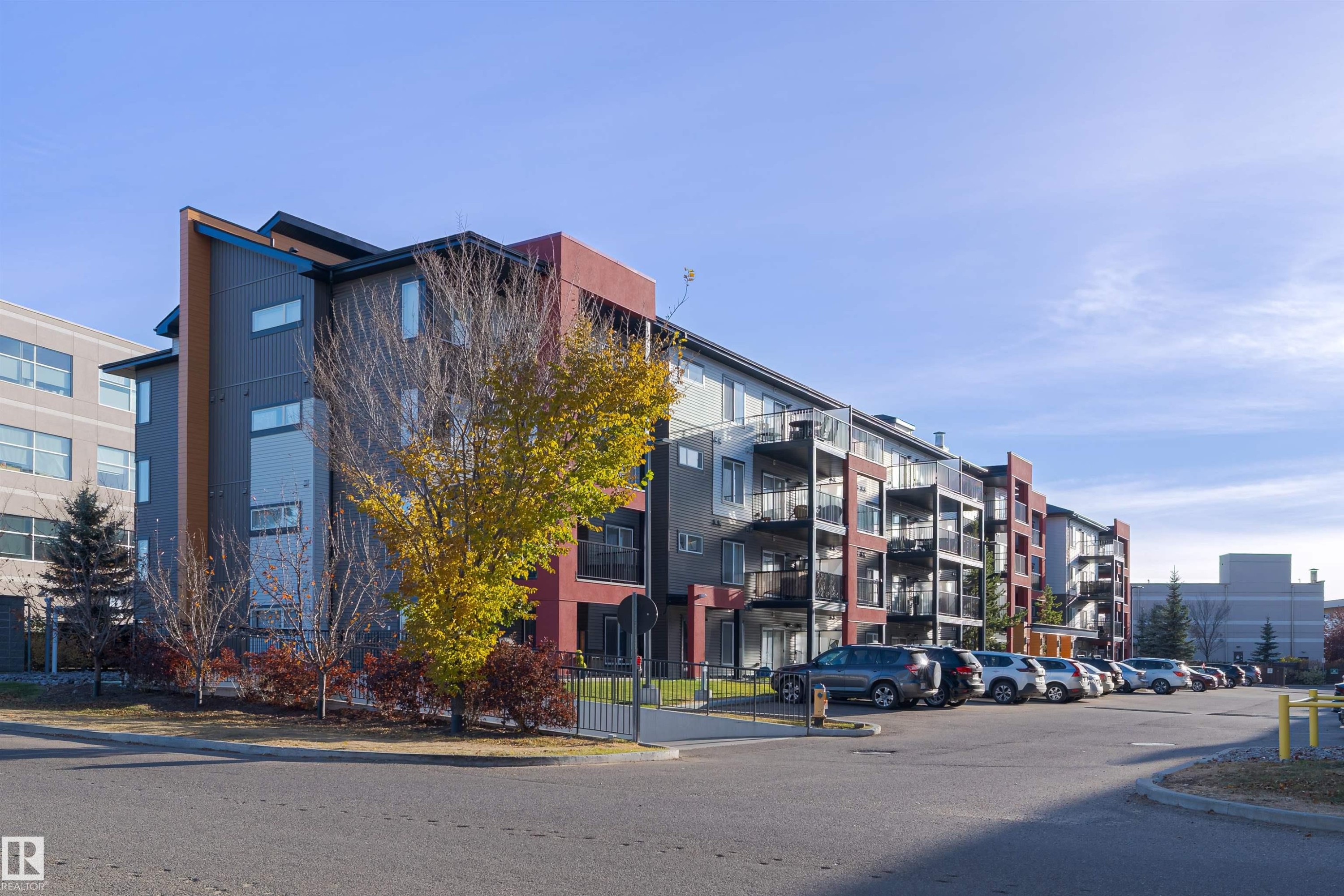 View of apartment building / complex with uncovered parking - 211 340 Windermere Road, Edmonton, AB - Outdoor With Facade