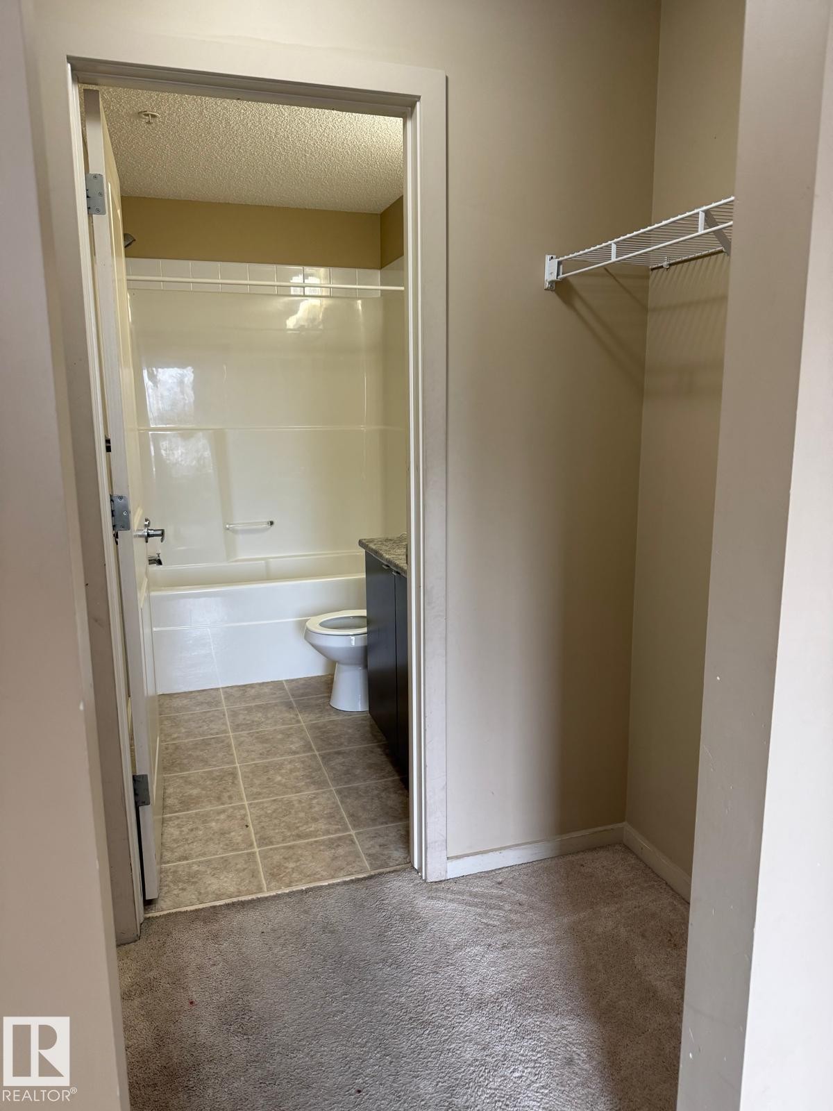 Bathroom featuring vanity, light colored carpet, and shower combination - 211 340 Windermere Road, Edmonton, AB - Indoor Photo Showing Bathroom