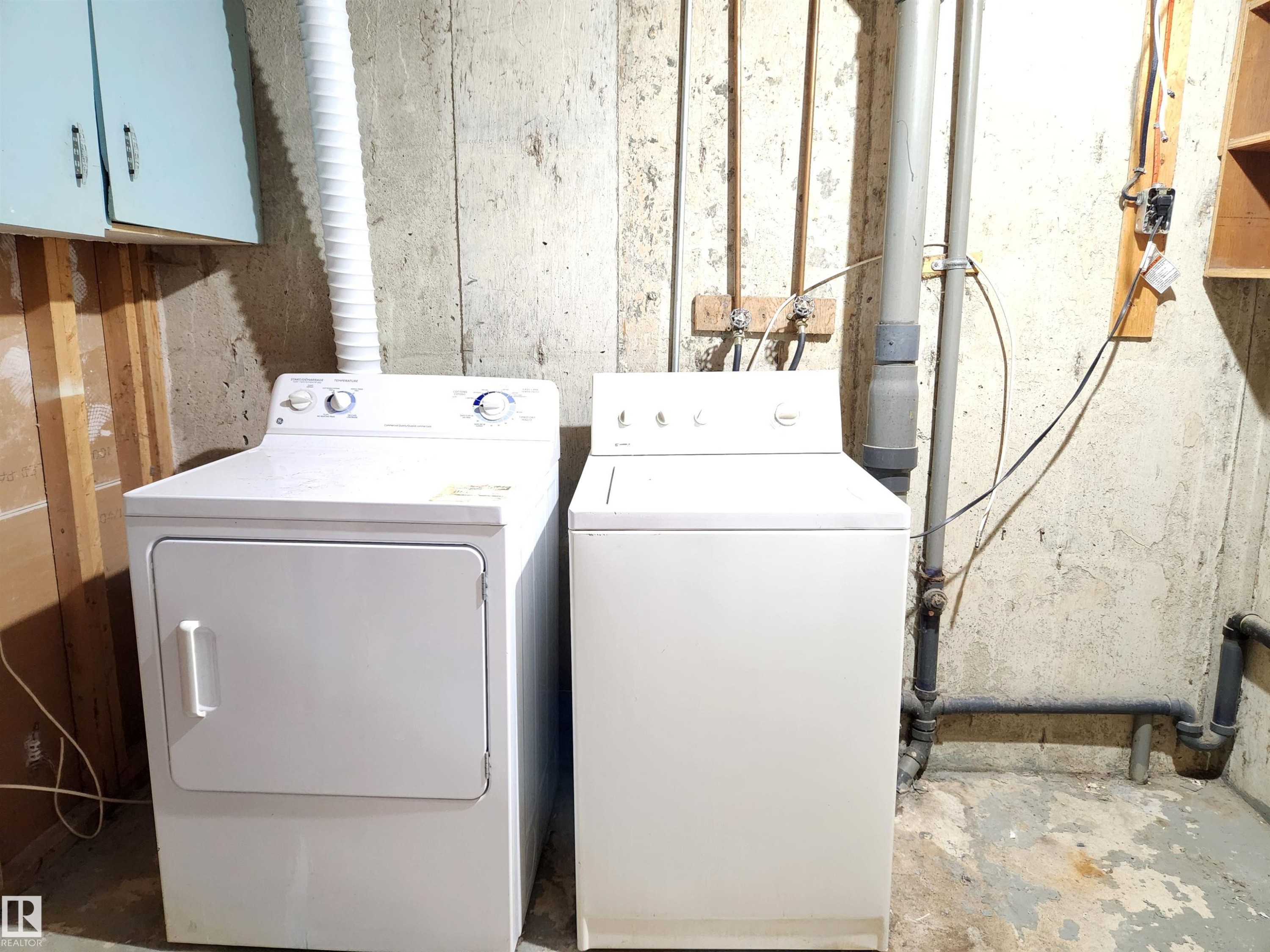 Laundry room with independent washer and dryer, concrete floors, and cabinet space - 6 14320 80 Street, Edmonton, AB - Indoor Photo Showing Laundry Room