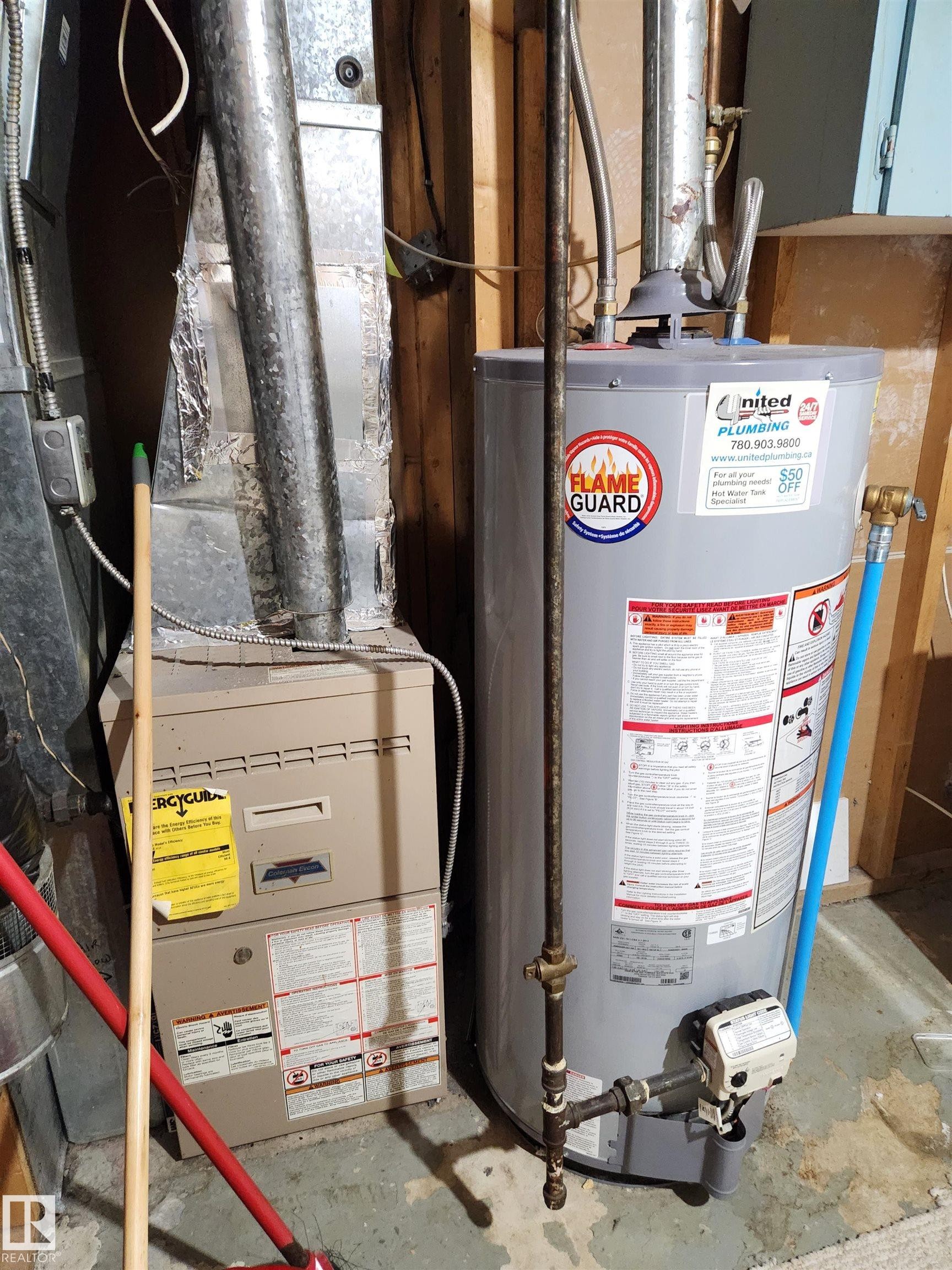 Utilities featuring gas water heater and heating unit - 6 14320 80 Street, Edmonton, AB - Indoor Photo Showing Basement