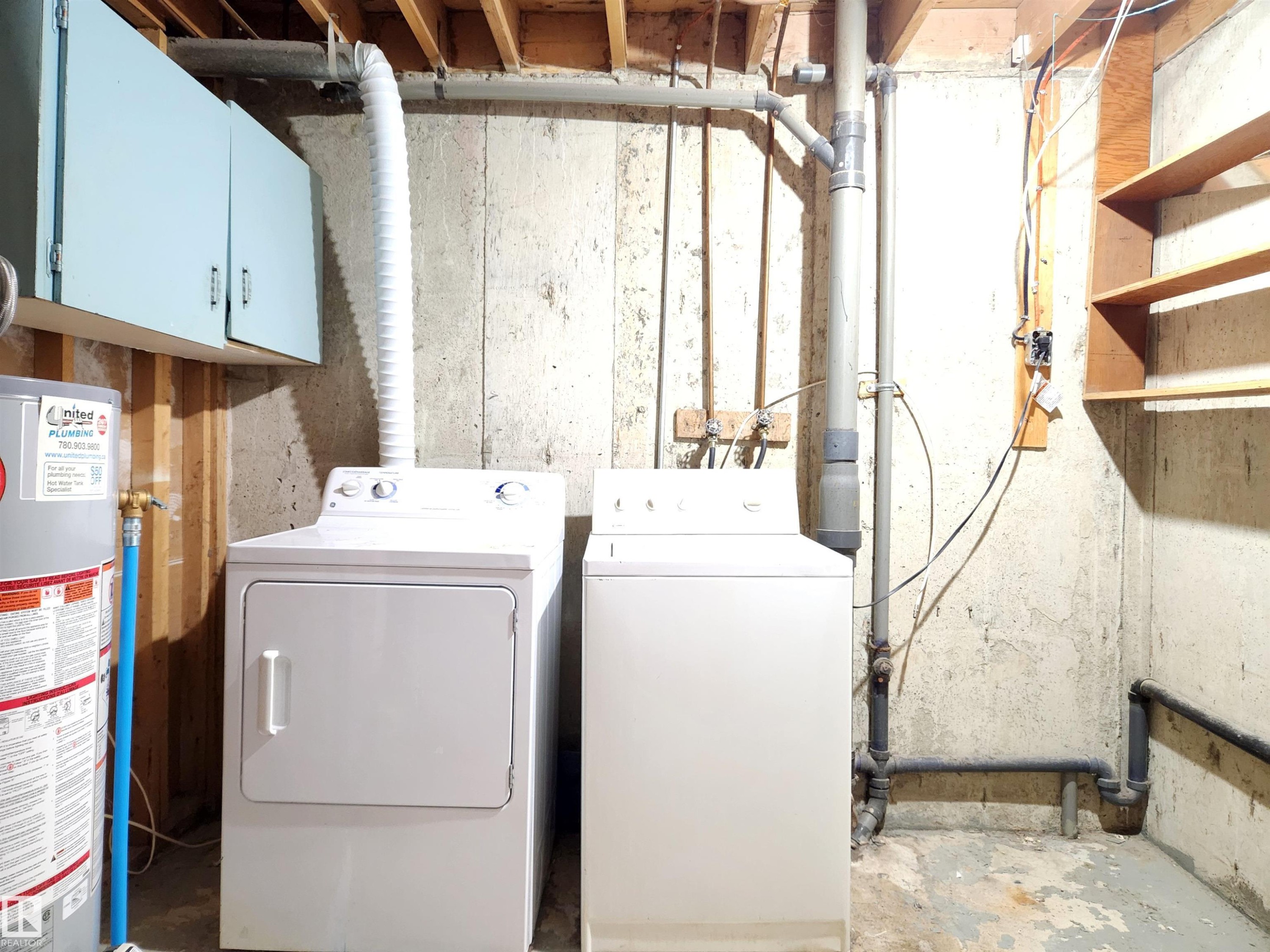 Laundry area featuring gas water heater, concrete flooring, and separate washer and dryer - 6 14320 80 Street, Edmonton, AB - Indoor Photo Showing Laundry Room