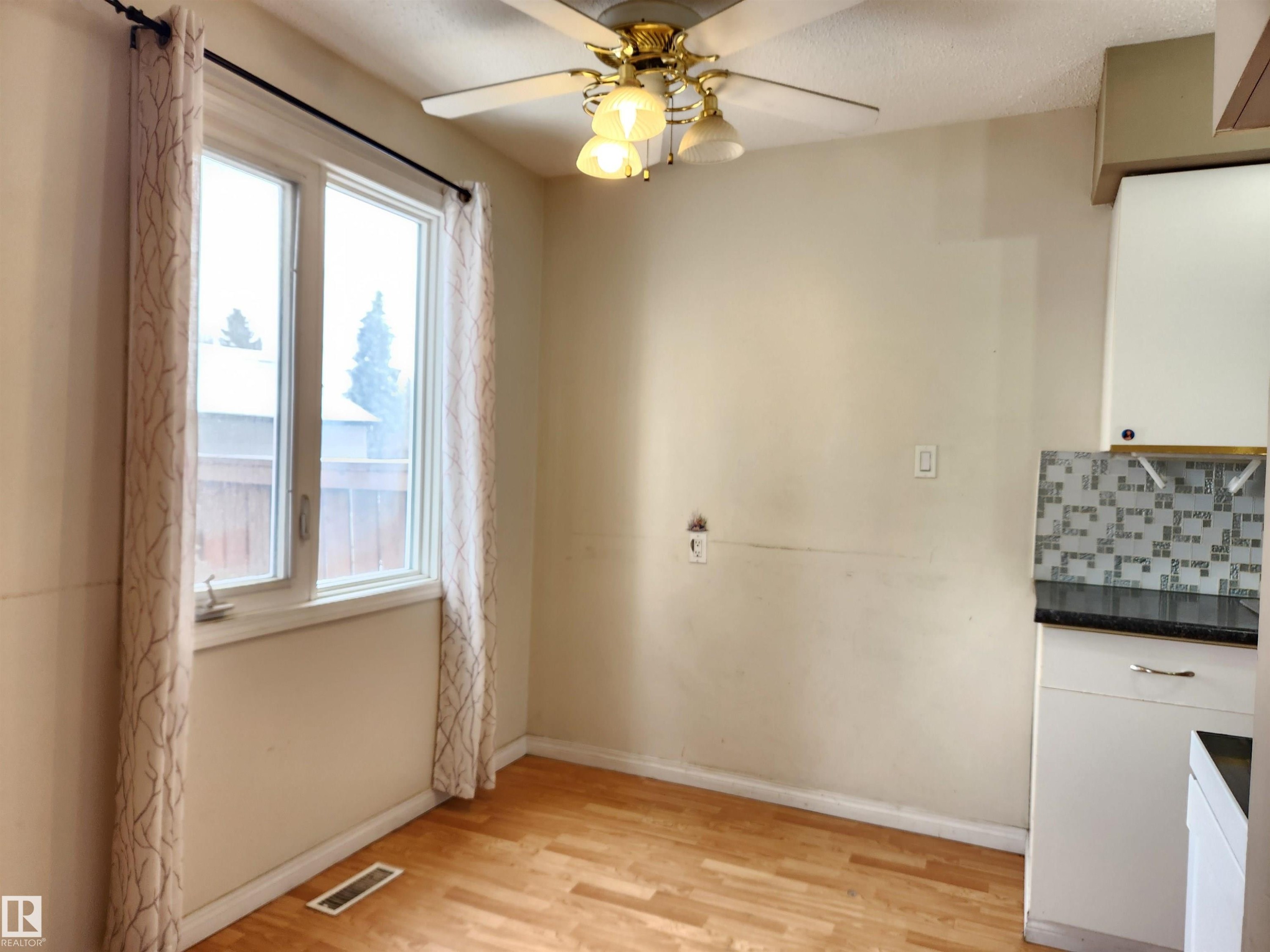 Unfurnished dining area with ceiling fan and light wood finished floors - 6 14320 80 Street, Edmonton, AB - Indoor Photo Showing Other Room