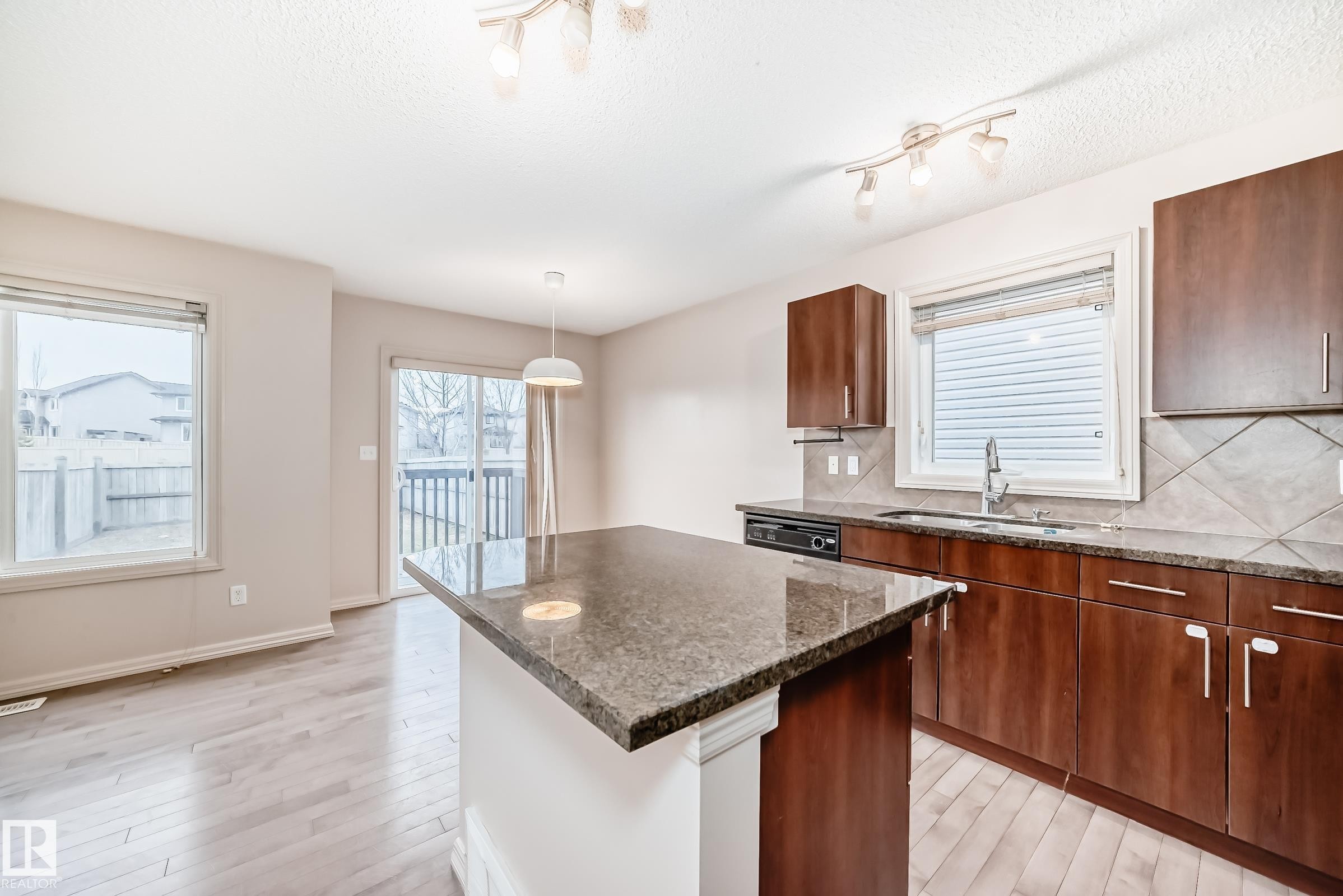 Kitchen island featuring a stone countertop - 1285 Cunningham Drive, Edmonton, AB - Indoor Photo Showing Kitchen