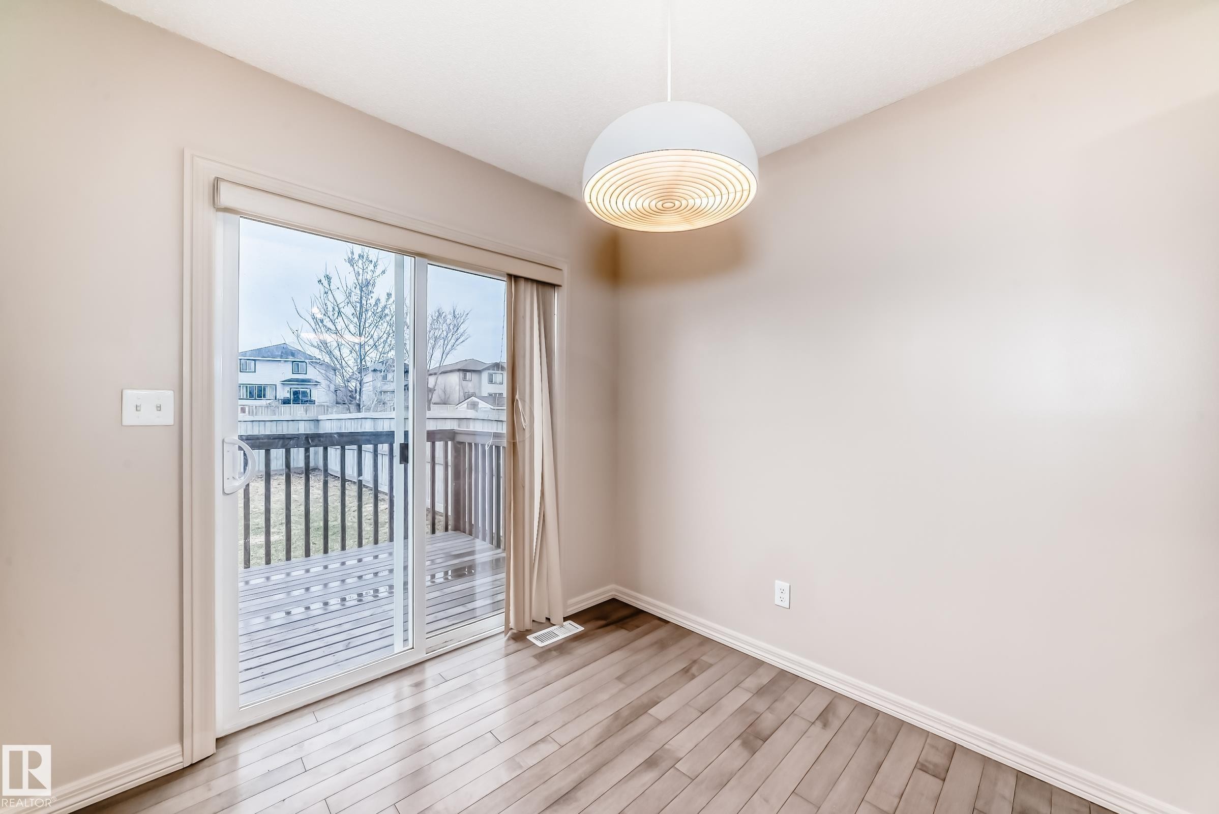 Light wood-finish flooring with neutral wall paint - 1285 Cunningham Drive, Edmonton, AB - Indoor Photo Showing Other Room