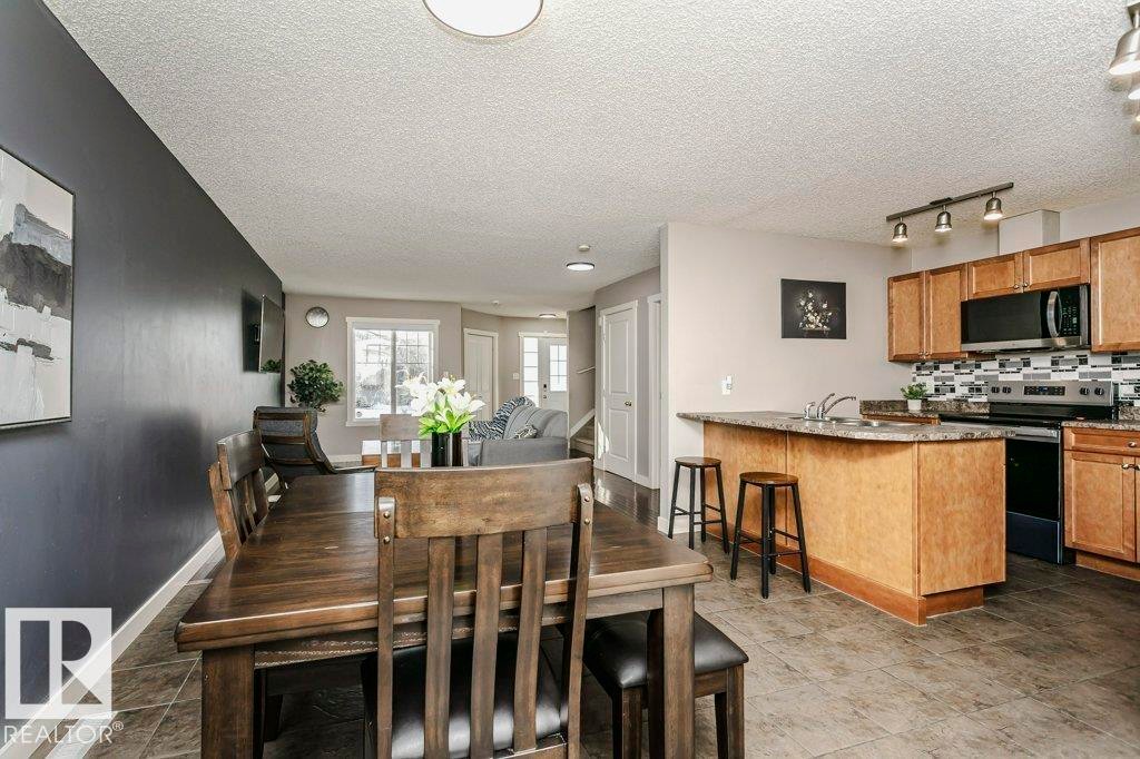 Dining area featuring a textured ceiling and track lighting - 1381 Rutherford Road, Edmonton, AB - Indoor