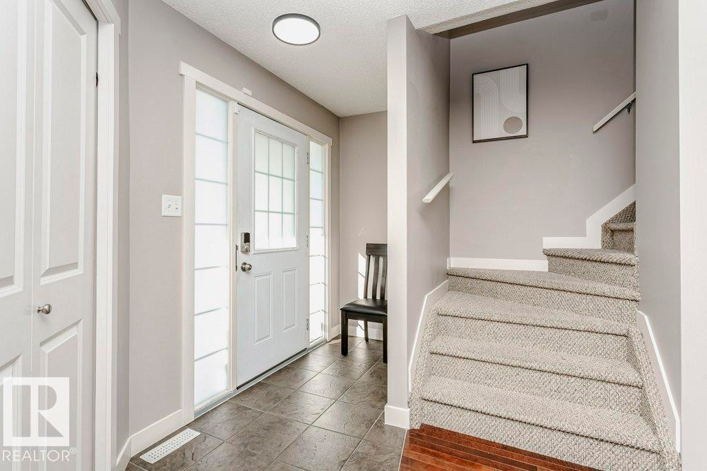 Foyer with stairs and a textured ceiling - 1381 Rutherford Road, Edmonton, AB - Indoor Photo Showing Other Room