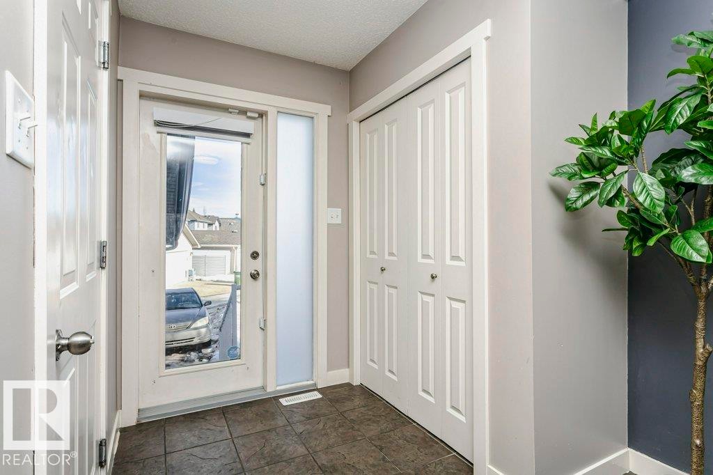 Foyer entrance featuring baseboards and a textured ceiling - 1381 Rutherford Road, Edmonton, AB - Indoor Photo Showing Other Room