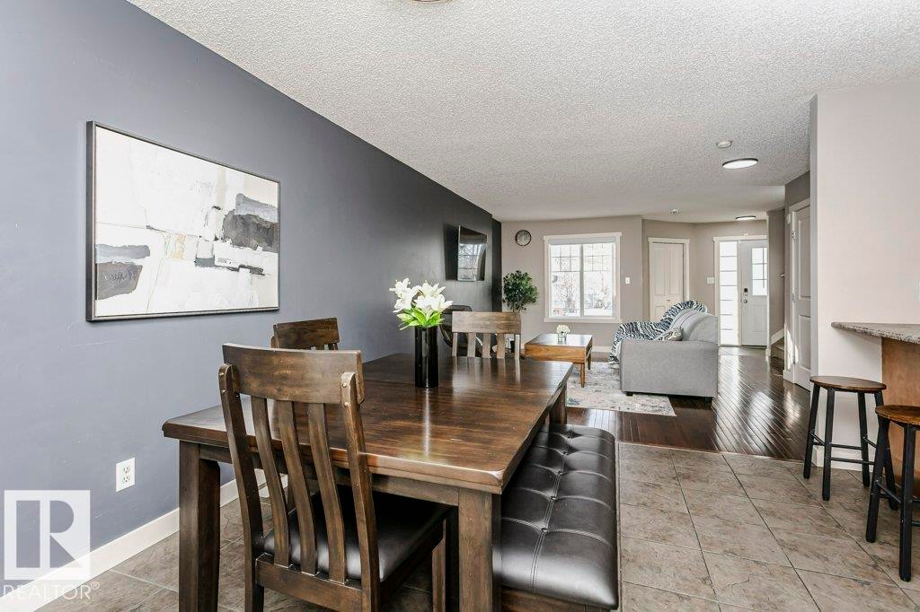 Dining room featuring light tile patterned floors, a textured ceiling, and recessed lighting - 1381 Rutherford Road, Edmonton, AB - Indoor Photo Showing Dining Room